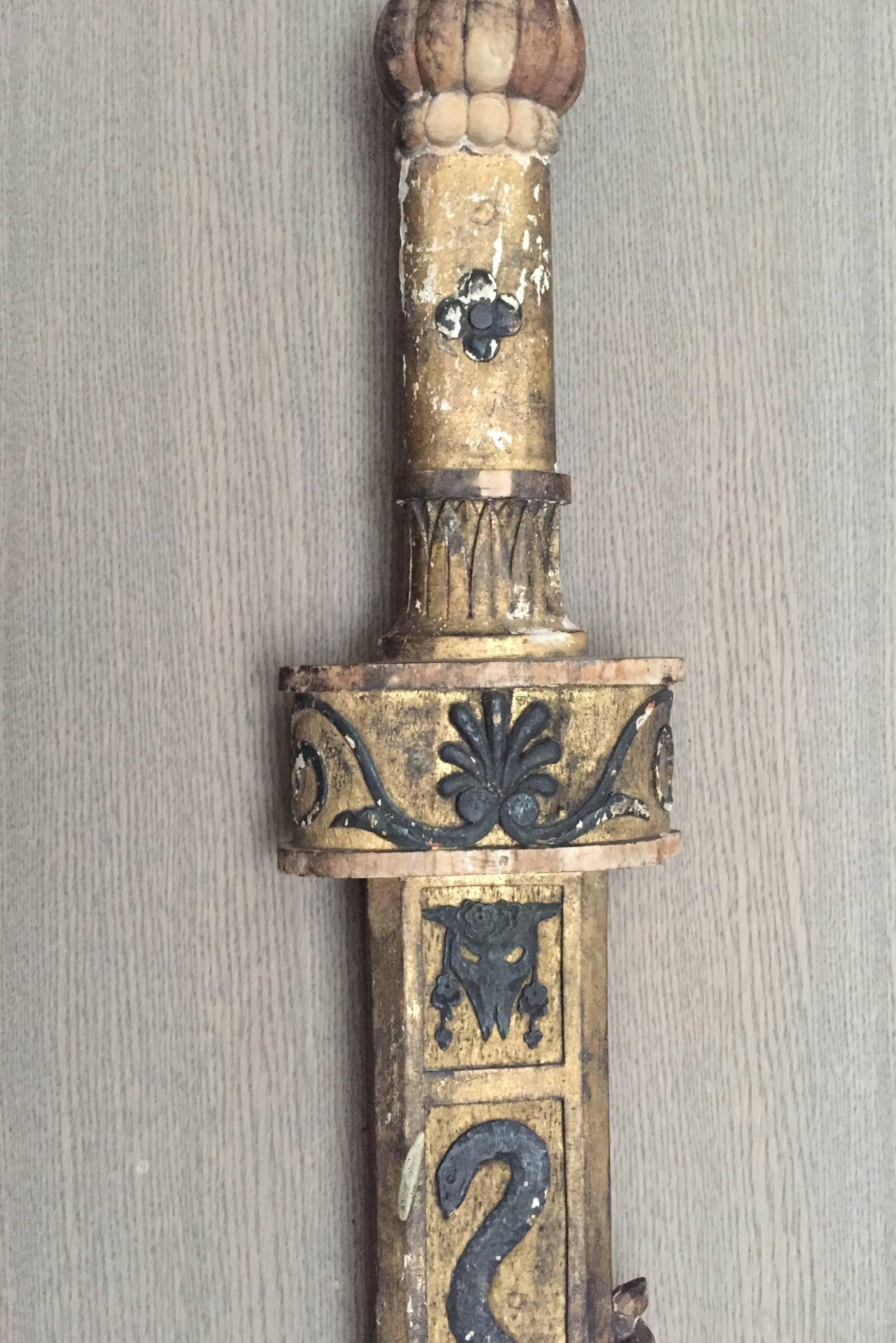 Highly decorative and elegant period neoclassical Italian carved wood sword. This sword was made as part of an ornate paneling and has the classical elements of the Roman Empire that popularized neoclassical design at the beginning of the 18th