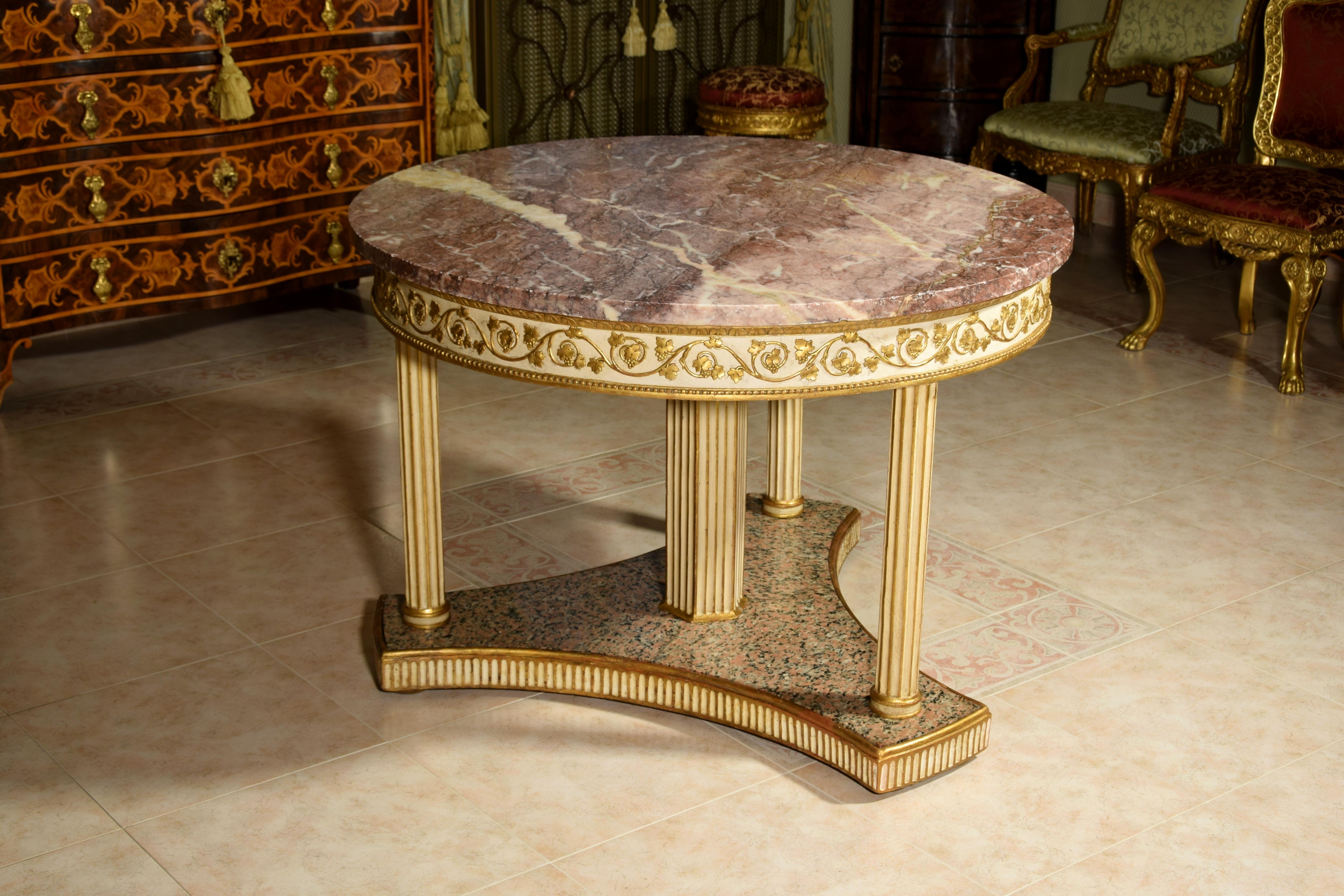 18th century, Italian neoclassical round lacquered wood center table with marble top

This elegant neoclassical table was made towards the end of the 18th century in central Italy.
It consists of a valuable marble top (