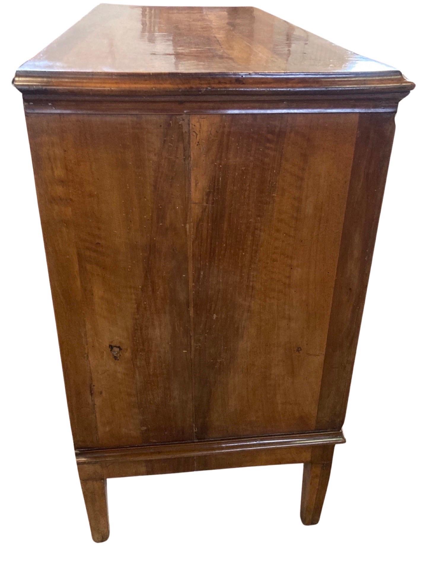 Stunning neoclassical / Louis XVI commode from central Italy hand-crafted in the mid 1700s using walnut and pegged construction. I, personally, fell in love when I saw it the first time because it is just a little different from every other commode