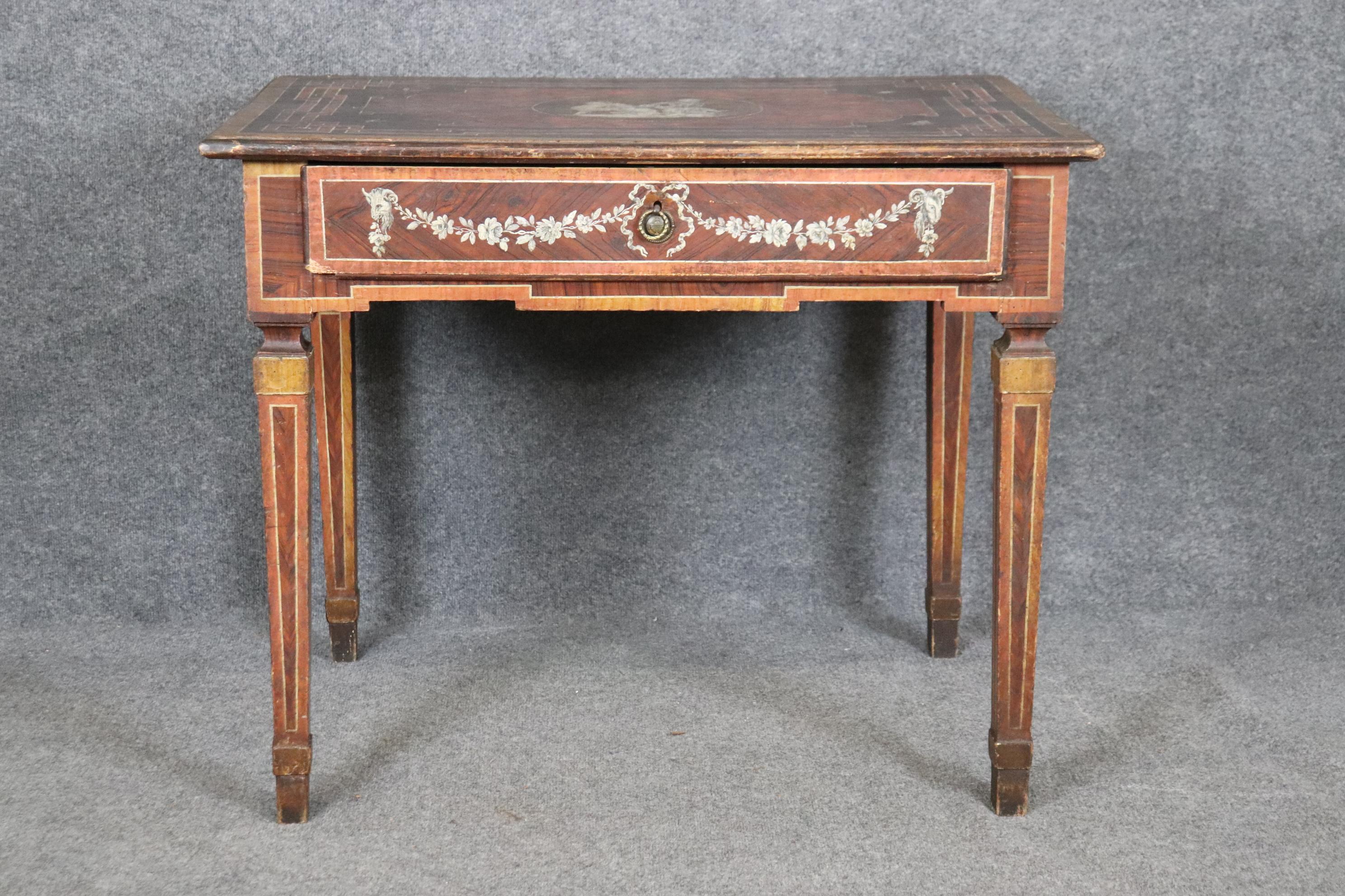 This is a gorgeous smaller true gem of a desk from the middle part of the 1700s from Italy. The desk is made of walnut and pine and has a single drawer with all the traits one expects from fine antique Italian furniture such as age checking, painted