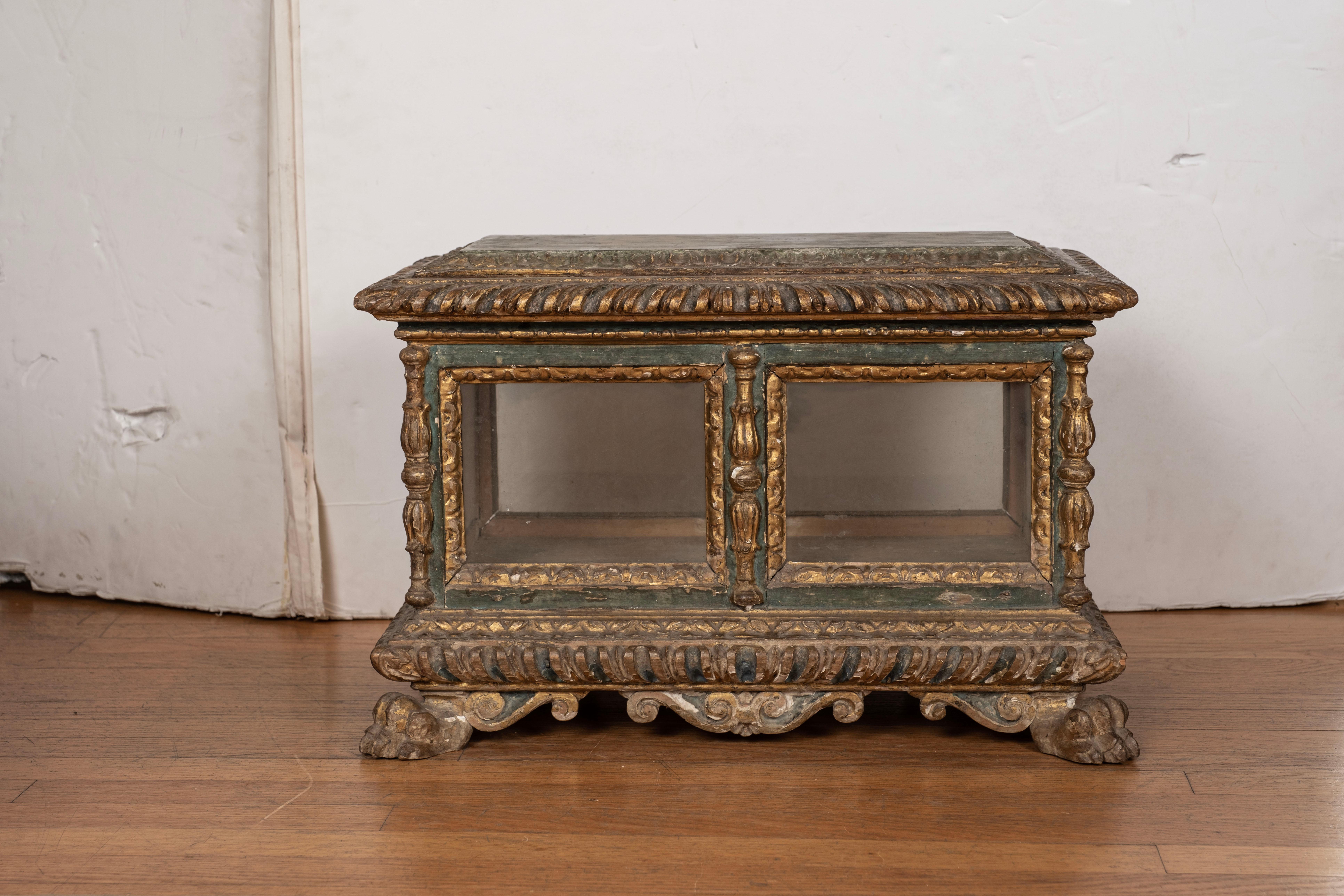 18th century Italian painted and parcel gilt reliquary box.
This lovely large Italian Baroque box is made of painted and parcel gilt wood surrounded by a glass front, sides and back.
This stunning 18th century reliquary box or decorative box can