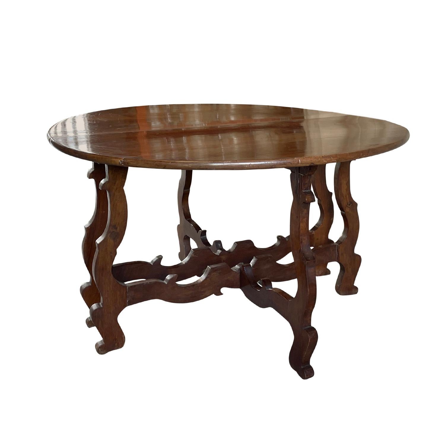 A pair of 18th century Tuscan Baroque tables or wall consoles in warm colored waxed finished Walnut wood with a wonderful grain, in good condition. These freestanding Italian demi-lune consoles have an elaborated design and the scroll elements are