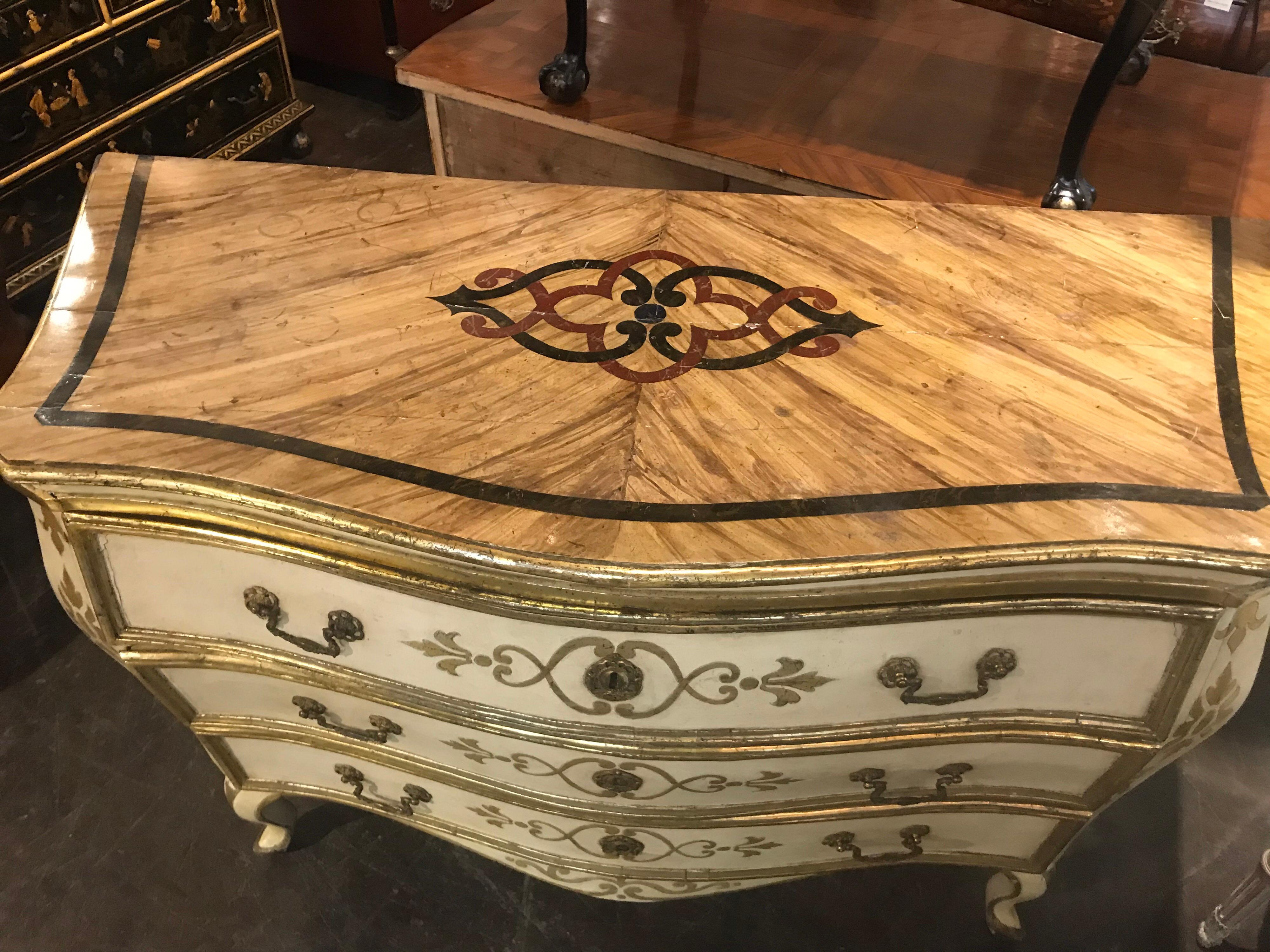 Beautiful 18th century Italian commode having a wonderful bombe’ shape and original parcel gilt finish. Interesting warm finished walnut top with ebonized inlay gives this piece added charm. Structurally very solid and pleasing to the eye. Fabulous