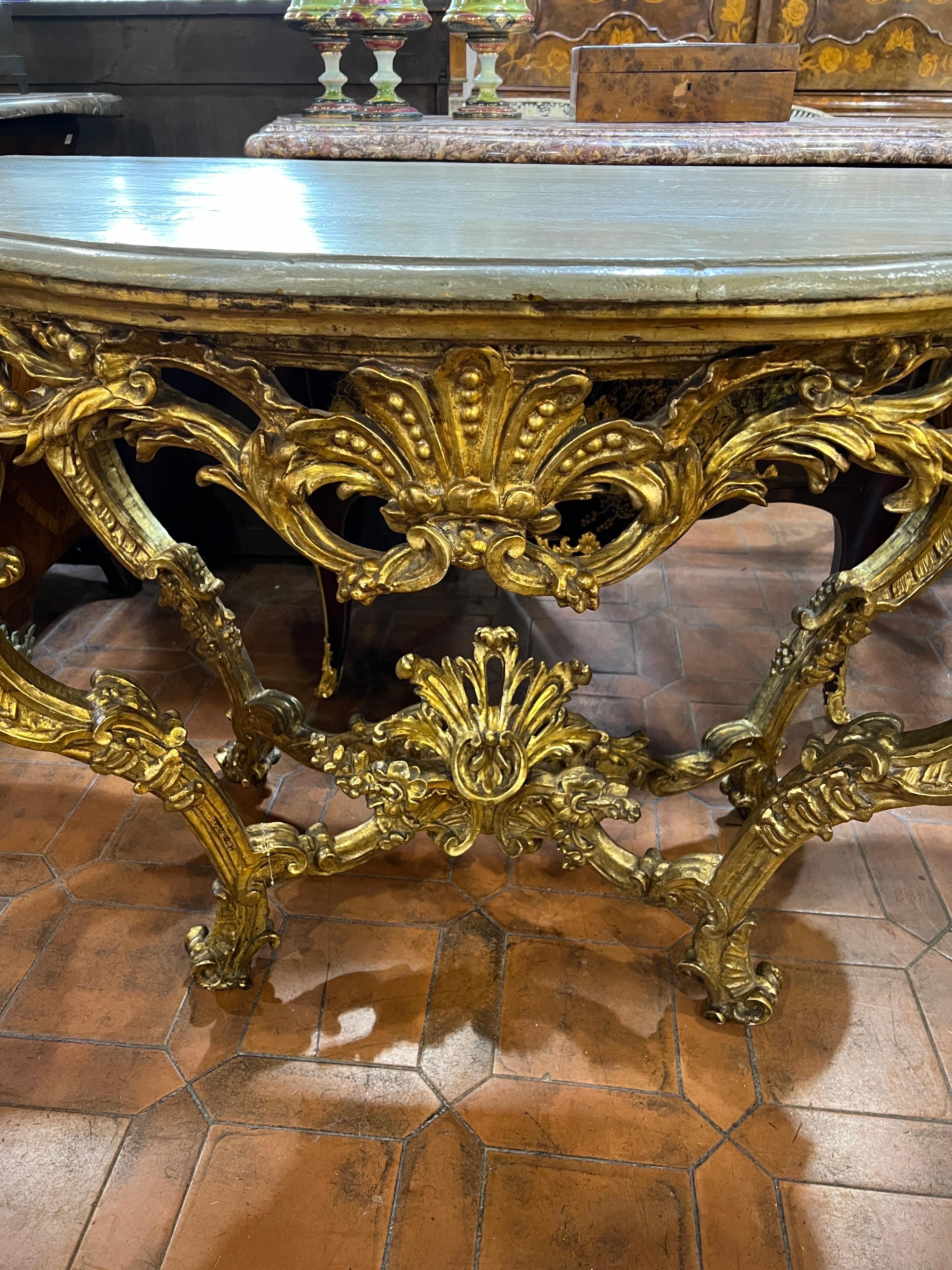 Fantastic Console of Sabauda provenance, Italy Piedmont region, carved and carved wood with floral and geometric motifs, gilded with gold leaf and gray-painted wood top, provenance Castello di San Giorgio Canavese, province of Turin. Provenance