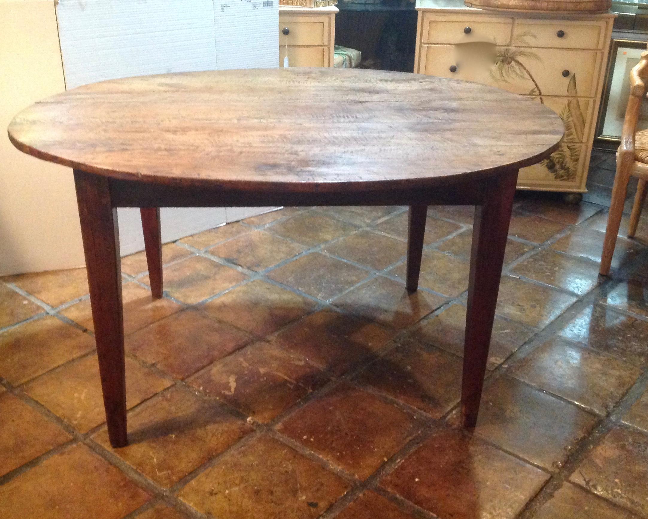 Great size and scale, with a mellow patina. The table is fashioned from walnut 
with a desirable oval form and tapered legs.