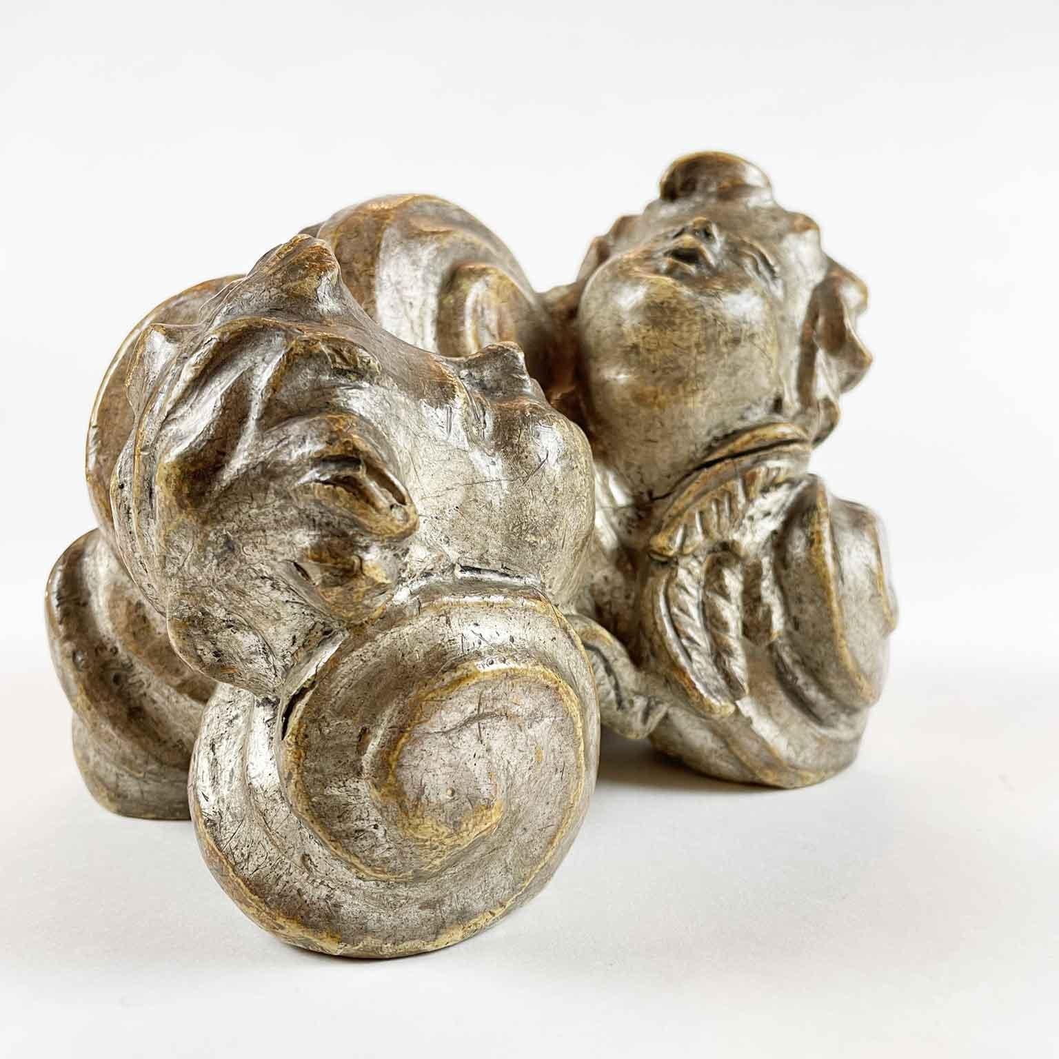 Antique Italian hand-carved and silvered base with cherubs dating back to the second half of 18th century, in good age related condition.

It is a cloud-shaped wooden base with scrolling carving, topped by two heads of winged Cherubs looking