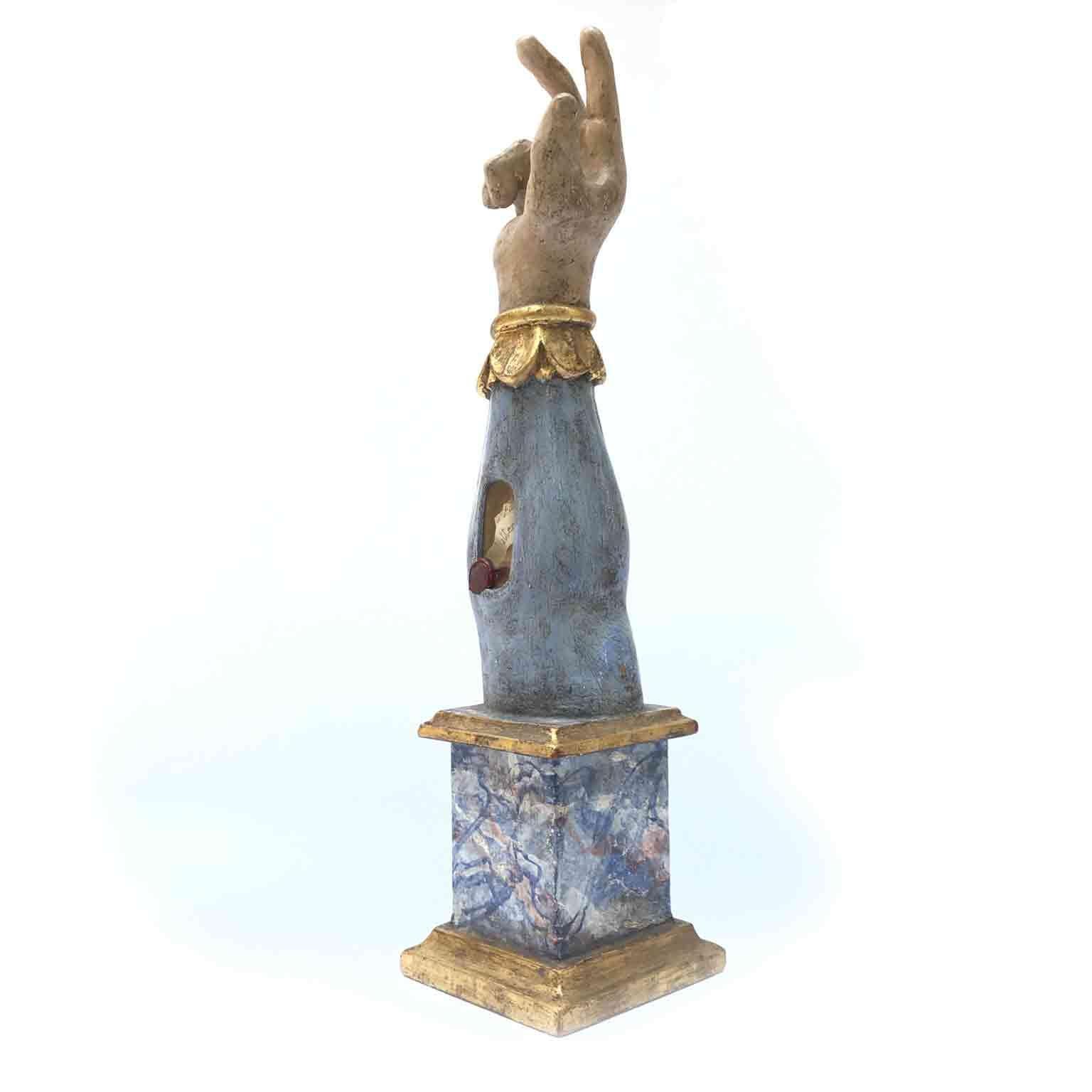 An unusual Italian arm reliquary of Saint Mathiew from Umbria, Central Italy, it is a carved wooden reliquary made in the shape of an arm and realized in the 18th century. The hand holds the thumb, first and second finger extended towards the