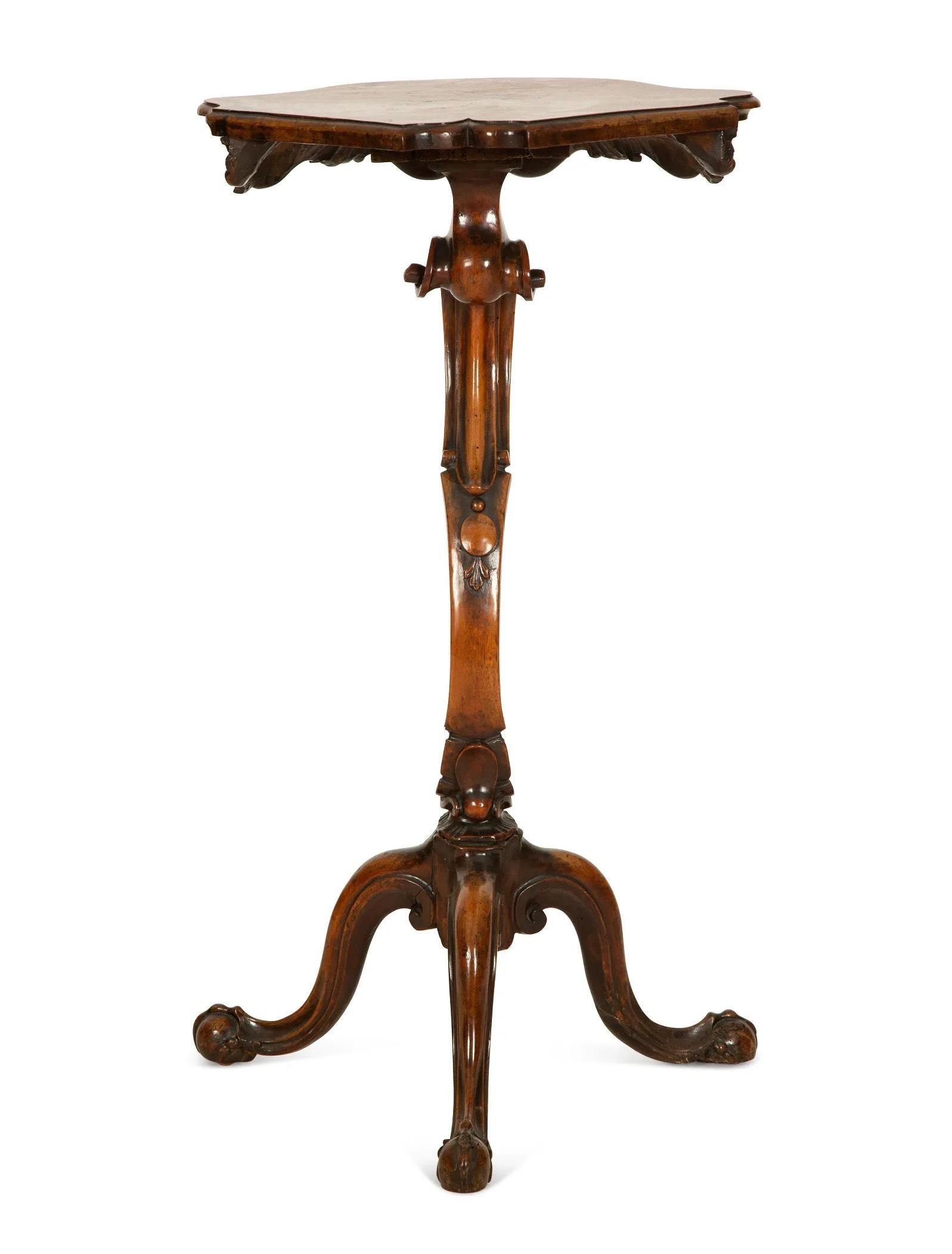 An Italian Rococo Walnut Gueridon À Trespolo, Pedestal.
Late 18th Century
With serpentine shaped walnut top above a carved shaped frieze raised on a carved scrolled support and three carved stepped legs.