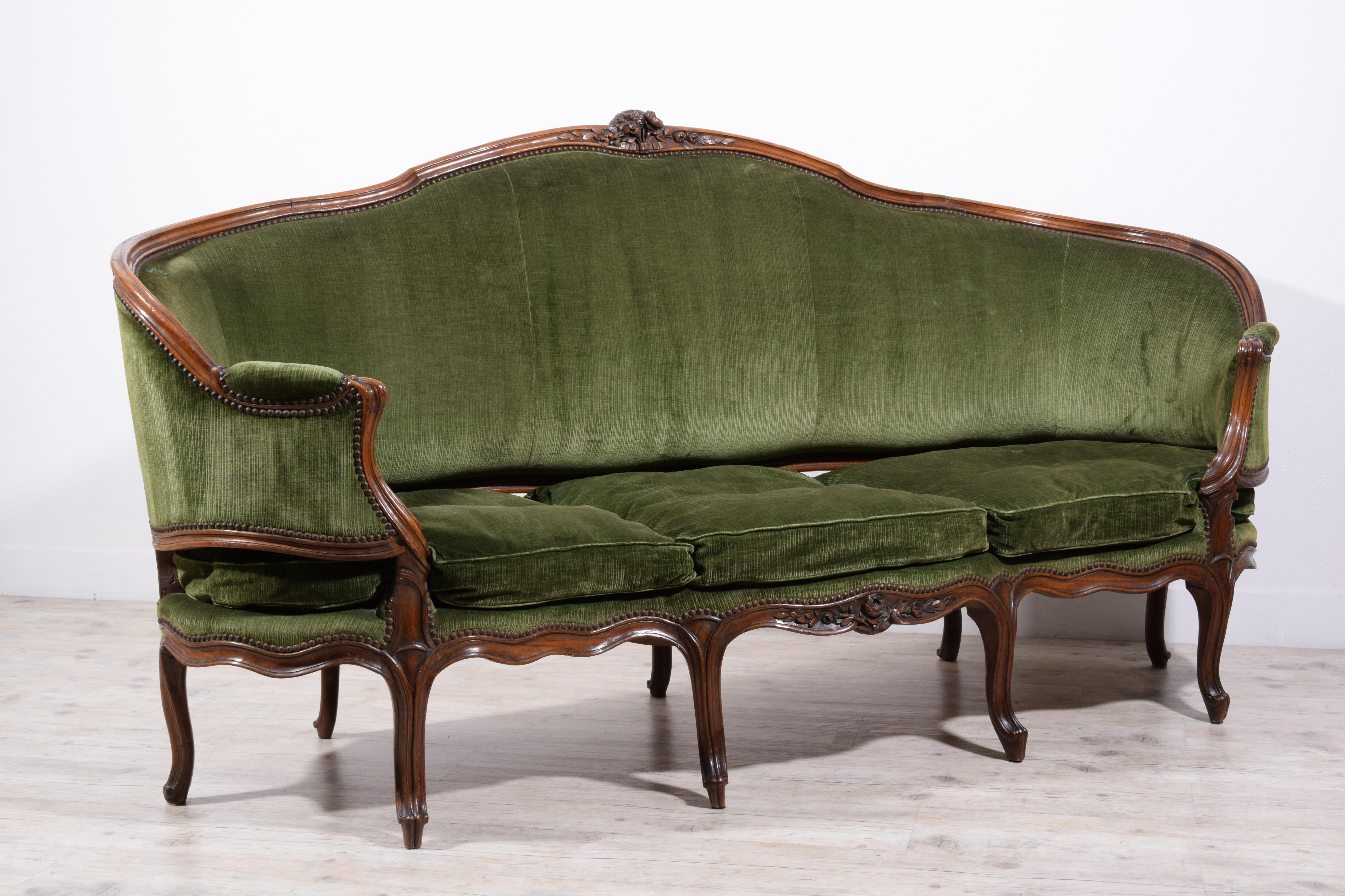 18th Century, Italian Rococo Carved Walnut Wood Corbeille Sofa

This refined corbeille sofa, made in Genoa, Italy, around the mid-18th century during the Rococo period, features a semi-oval structure whose backrest curves smoothly into the armrests