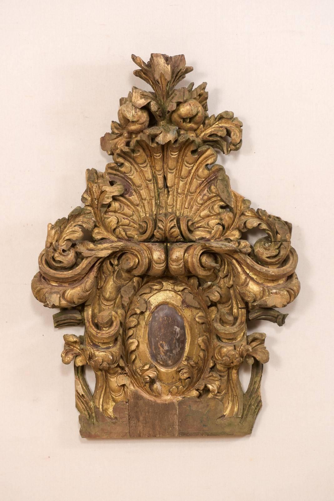 An Italian 18th century Rococo carved wood fragment. This antique wall decoration from Italy features fabulously detailed three dimensional hand carvings in a shell and scrolling acanthus leaf motif. The upper crest is raised to an impressive peak