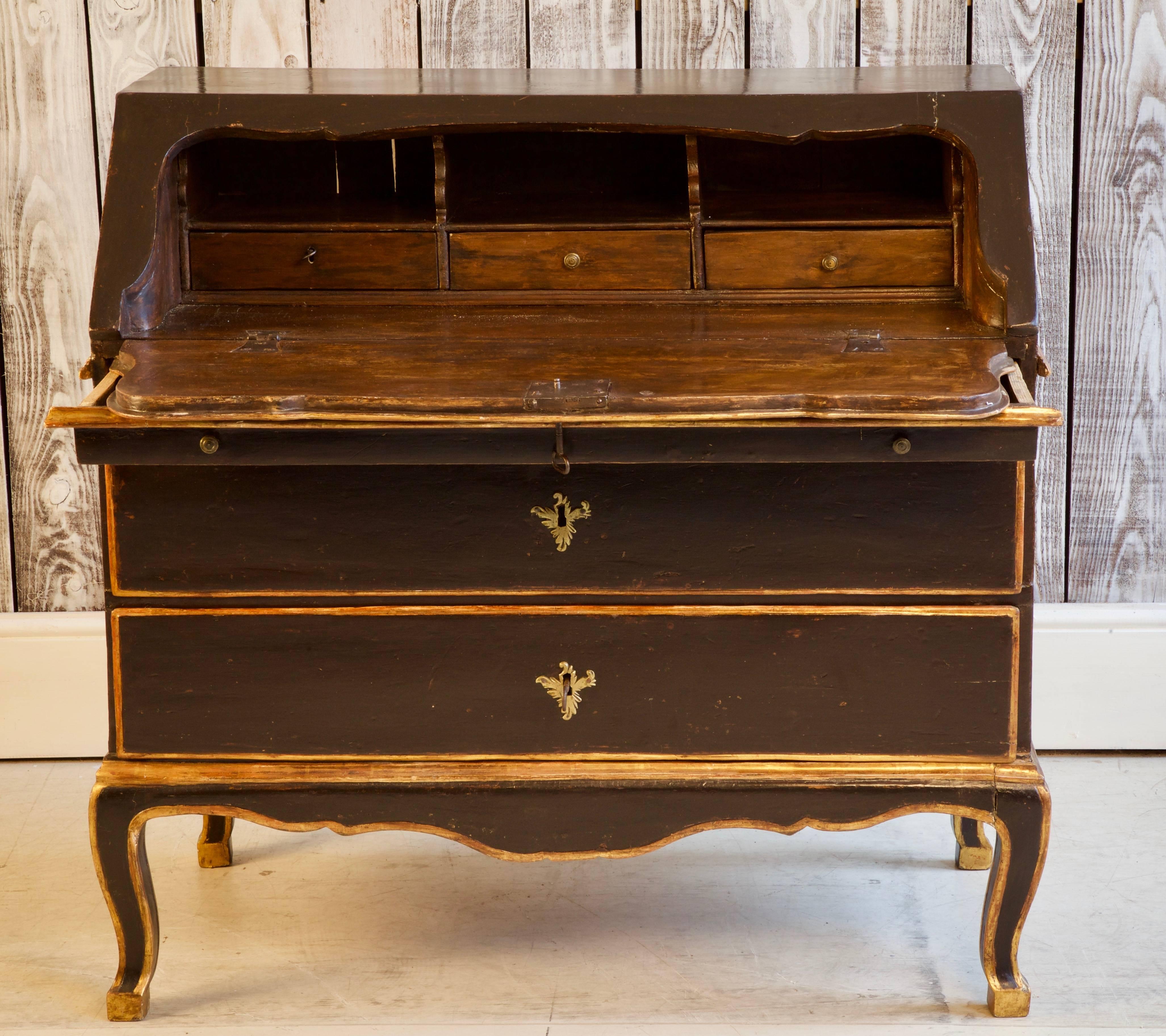 18th Century Italian scriban from Tuscany. Wax polished, walnut wood finish on the interior and a black lacquer patina with gilded highlights on the exterior. Complete with original ormolu fittings.