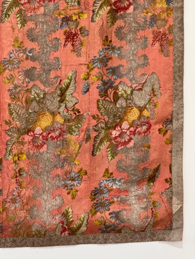 Beautiful Italian silk and metallic thread brocade panel, multi-colored flowers on a pink background, bordered in gold thread trim.  55.5” l x 42.5” w.

