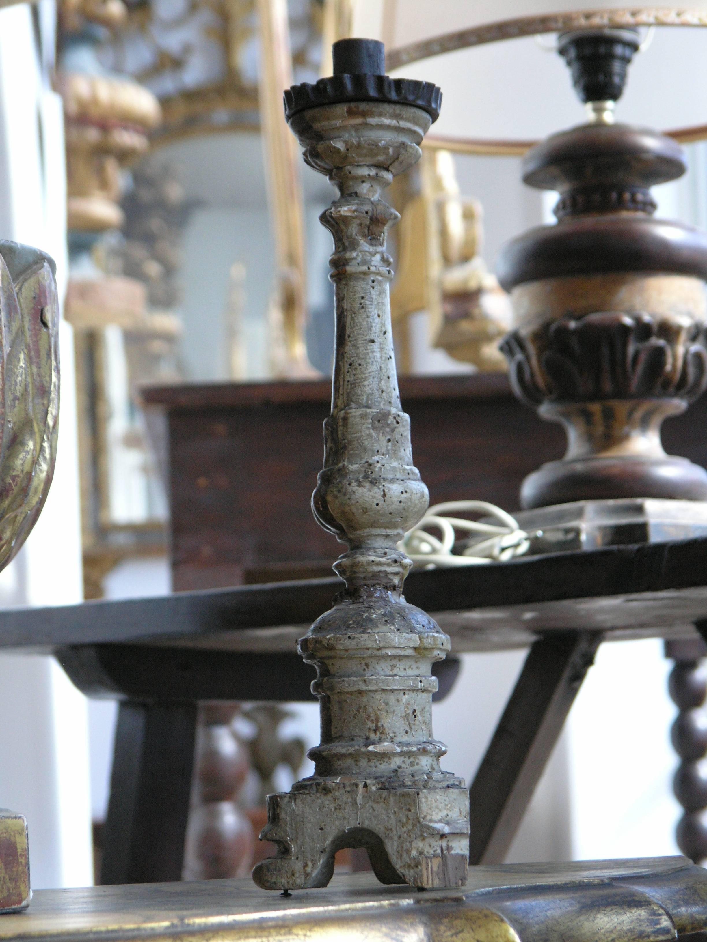 Baluster standard carved with foliage supporting a platform, raised on tripartite base.