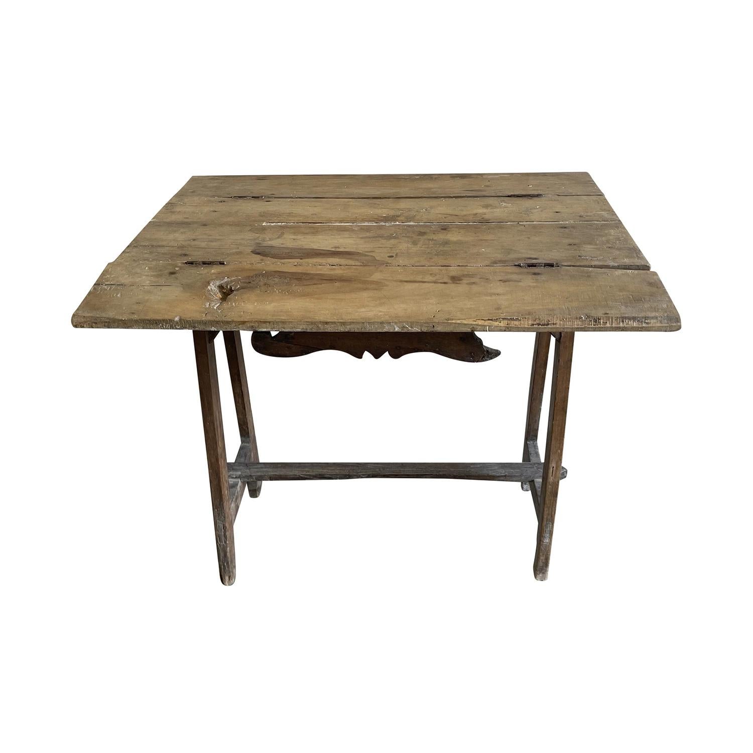 A small foldable 18th Century Tuscan Baroque side table or console has a warm rich patina, in good condition. The walnut table has a colored waxed finish. This petite Italian table has an elaborated design with a small drawer. The charming side