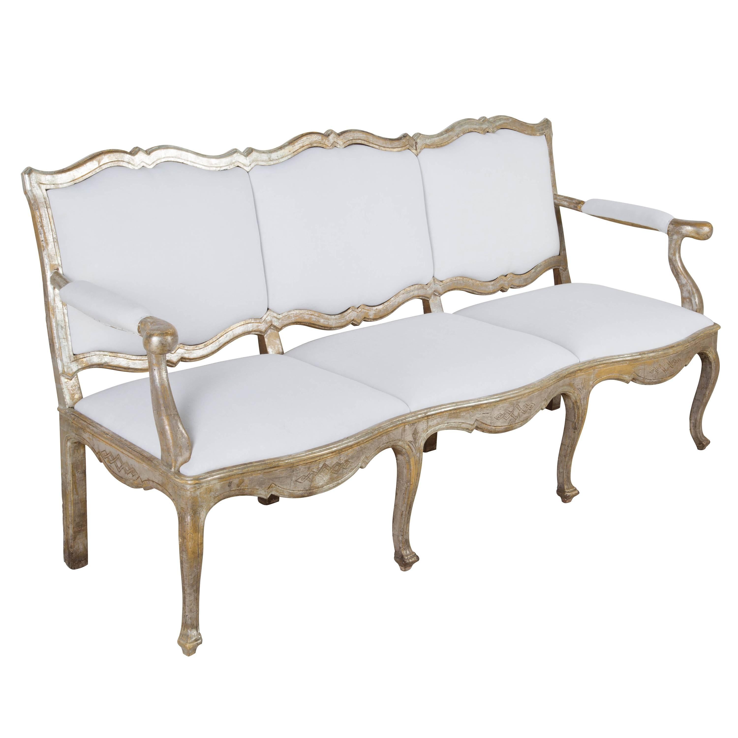 Late 18th century Italian three-seat sofa in original silver leaf. Measures: Seat height 42 cm, seat depth 55 cm.