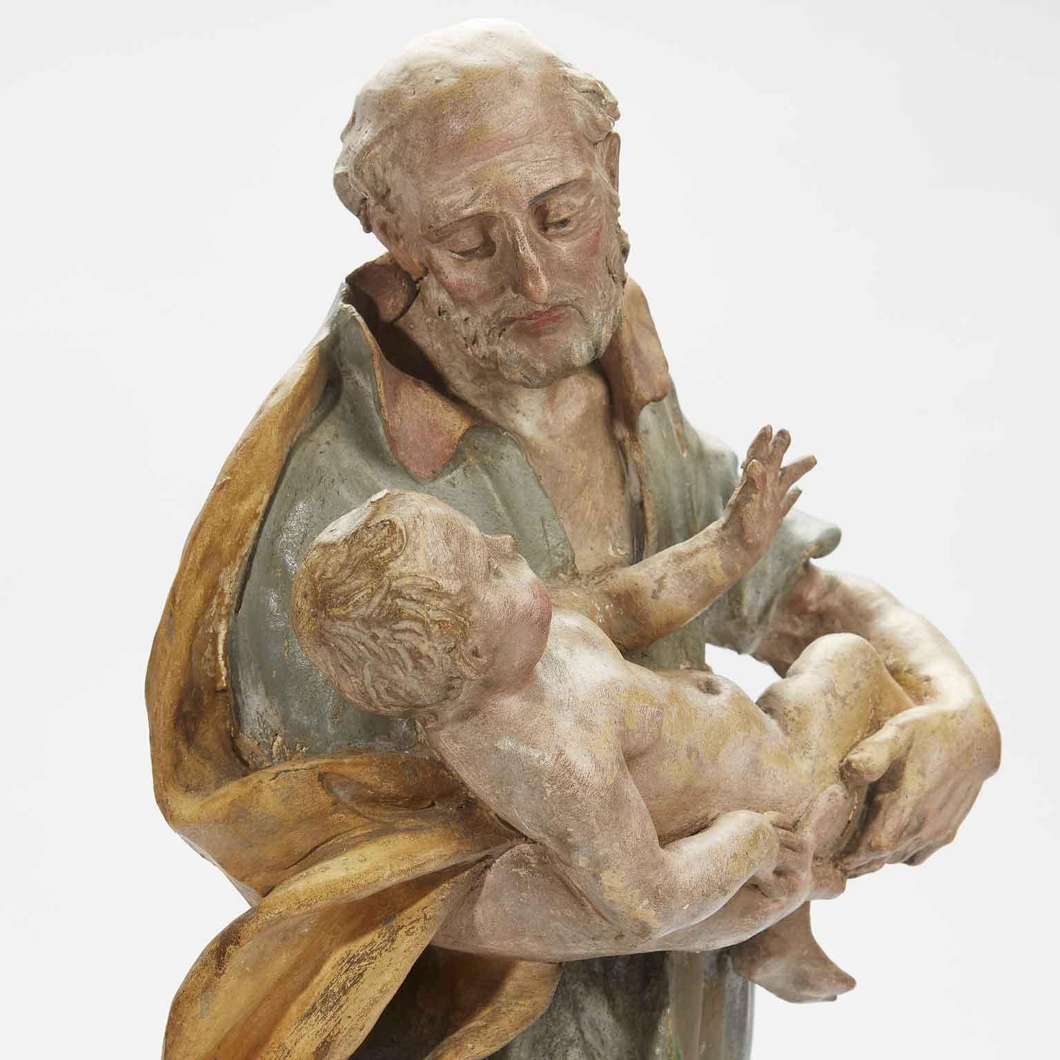 Escultura barroca italiana del siglo XVIII de San José con el Niño Jesús del Viejo Maestro Pintado a mano en venta