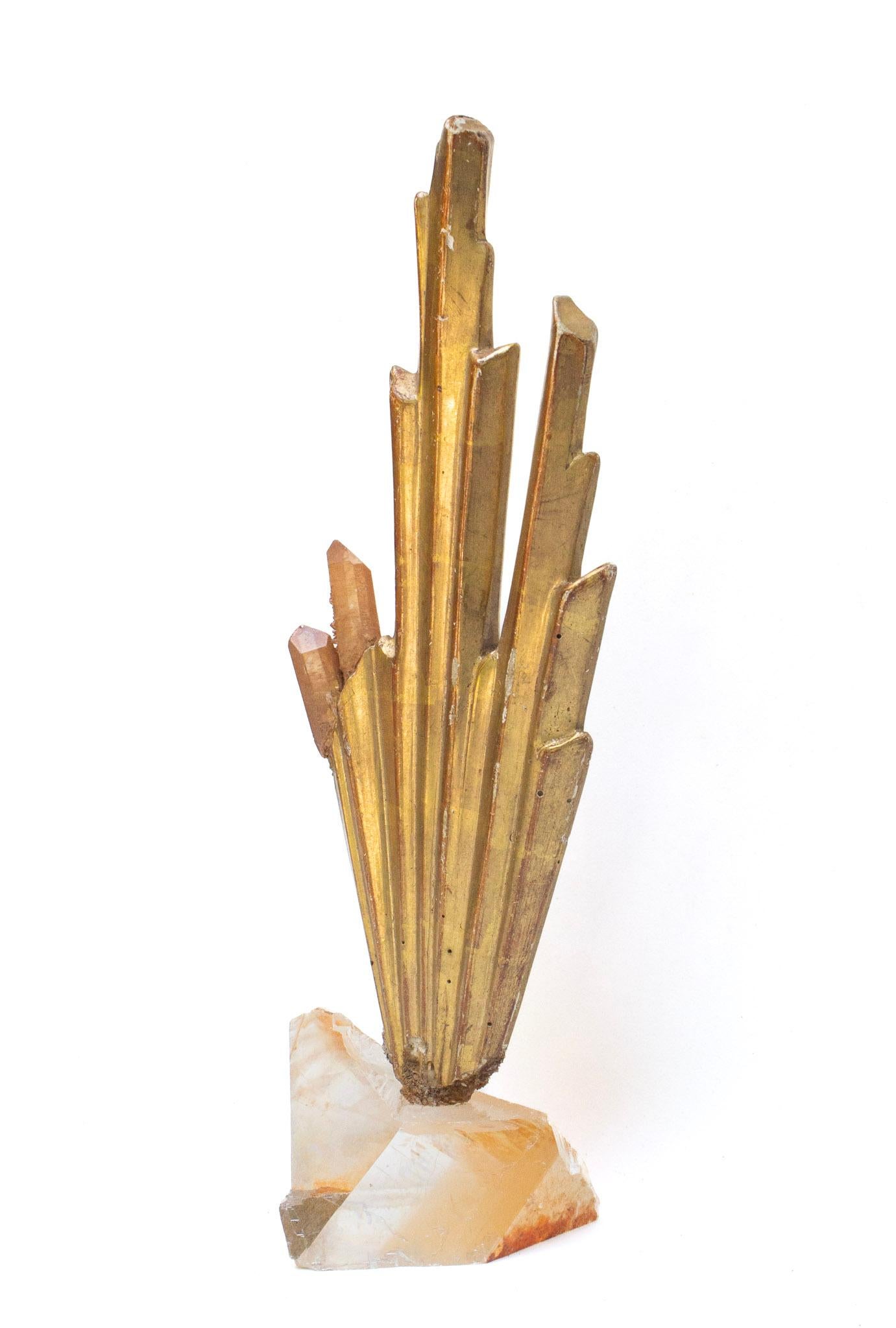 18th century Italian gold sunray fragment with tangerine crystal quartz points on a polished optical calcite base. The hand-carved, hand-painted wood fragment sunray was once part of an angelic, heavenly depiction or halo motif in an Italian church.