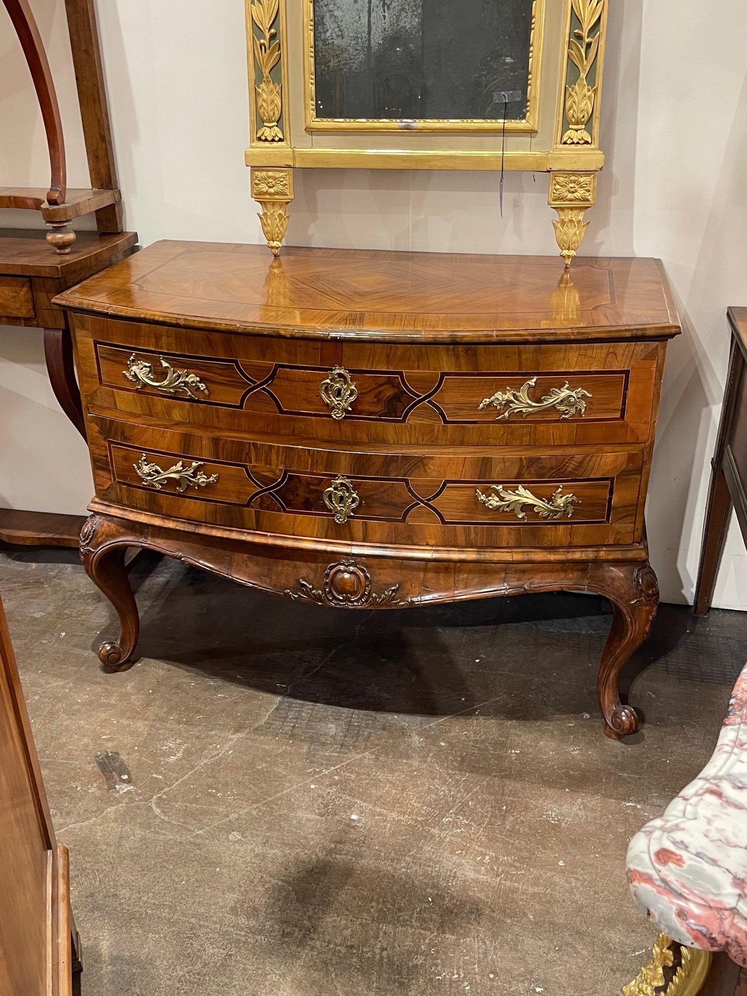 Elegant 18th century Italian walnut and inlaid wood commode. Beautiful finish and lovely decorative hardware as well. An exquisite piece!
