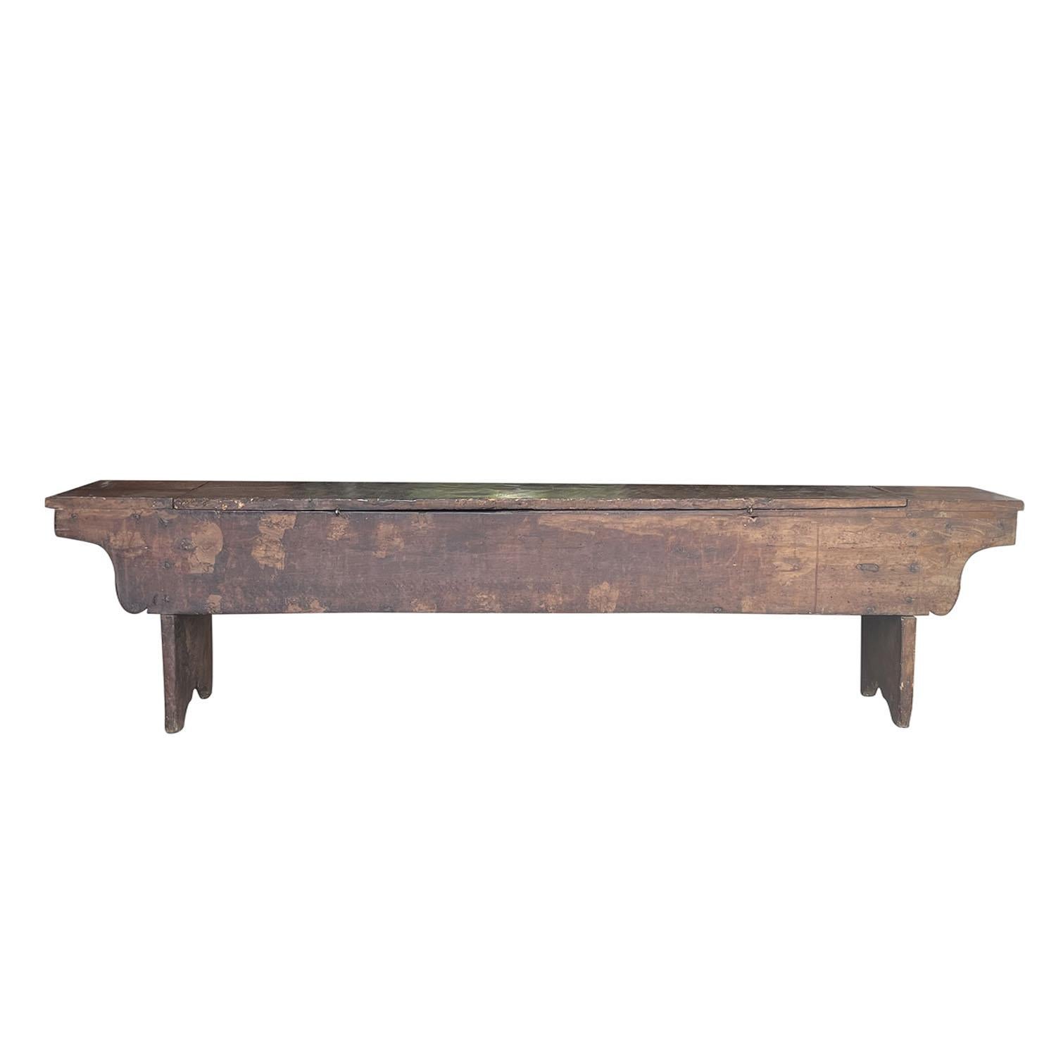 A detailed, antique bench made of hand crafted Walnut, in good condition. The cassa panca is composed with a liftable seat and a large storage underneath. Original condition and finish. Weathered patina. Minor fading, scratches due to age. Wear