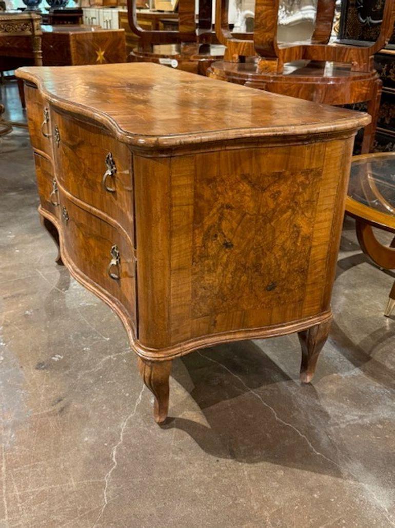 This handsome 18th Century Italian Walnut Bombe' Shaped Commode features a beautiful finish. This gorgeous chest combines traditional design with functionality, creating a timeless and luxurious aesthetic that is sure to impress. Circa 1780   Note:
