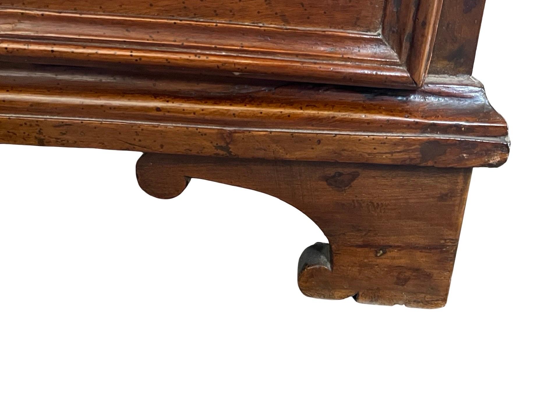 Commode hand-made in central Italy in the early 1700s using walnut and decorated with walnut and fruitwood inlay. The commode features three inset drawers all with beautiful hand-made dovetail joints, and decorated on the front with geometrical