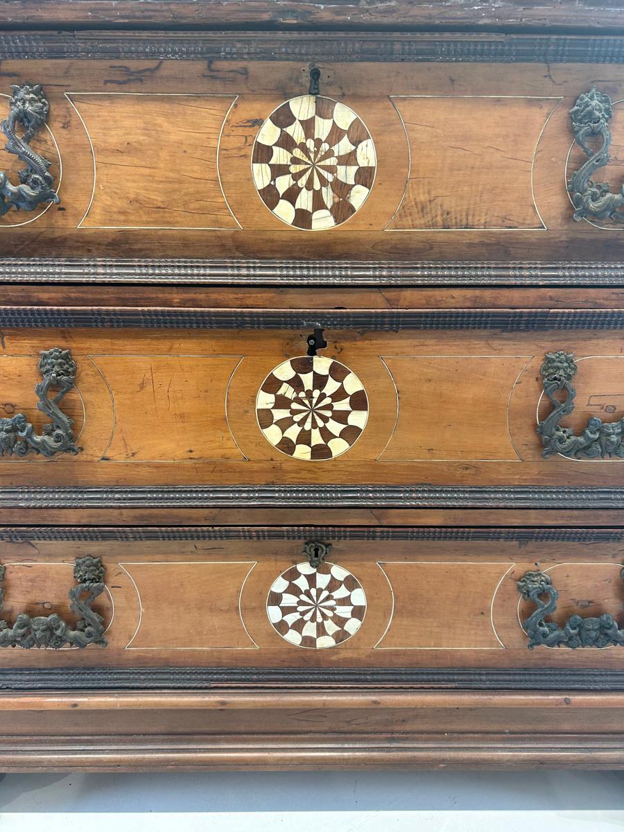 Enhance your home with the opulent elegance and masterful craftsmanship of this 18th Century Italian Walnut Chest with Bone Inlay. From its rich walnut finish to its intricate bone inlay, this chest is a testament to the artistic excellence and