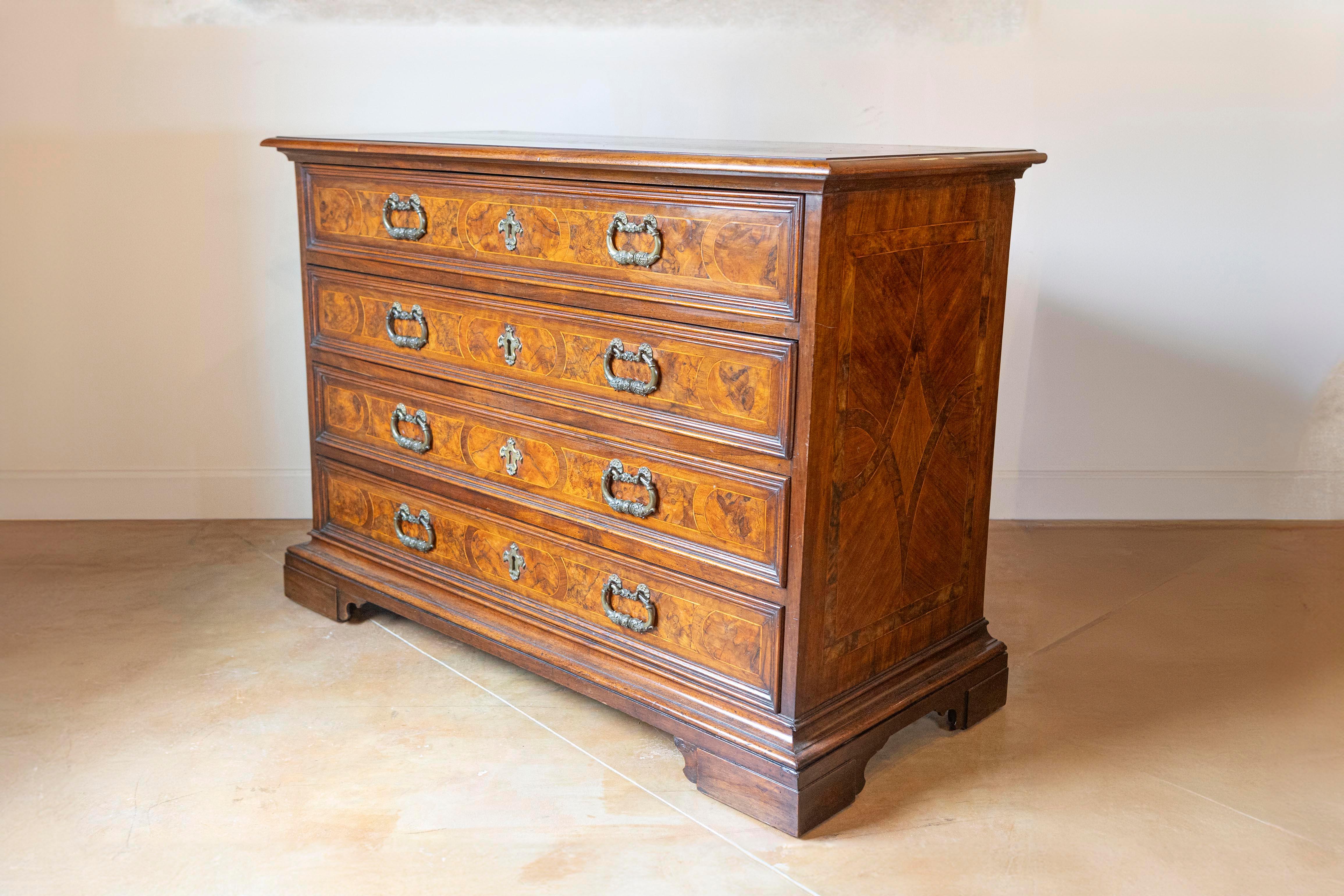 Carved 18th Century Italian Walnut Commode with Four Drawers and Ornate Hardware For Sale