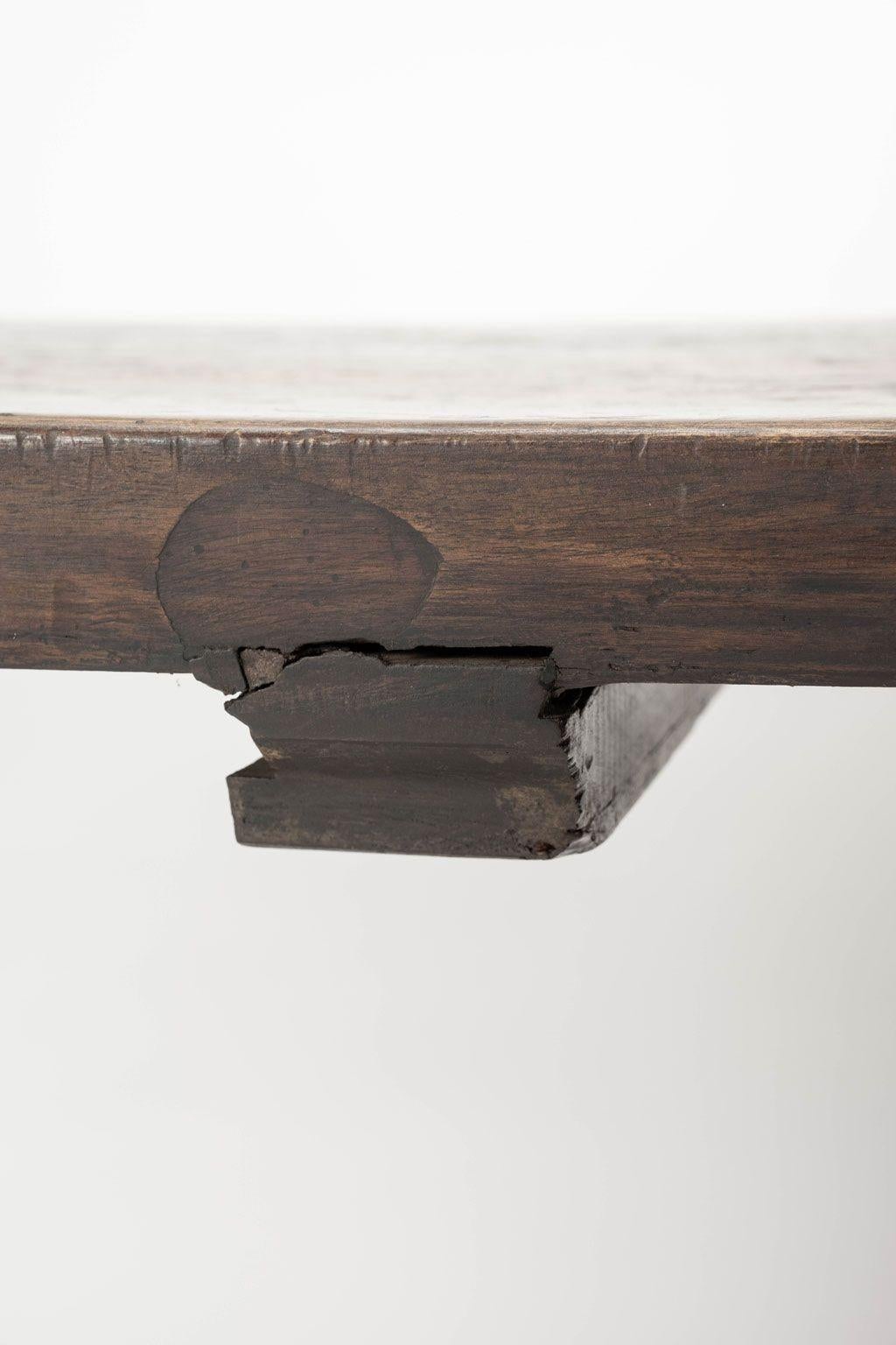 18th century Italian walnut console circa 1721-1759. Nice thick single plank top with varied shades of brown in a mottled finish. Early plug repair in top. Trestle base. Joints recently tightened. Substantial, sturdy and stable.