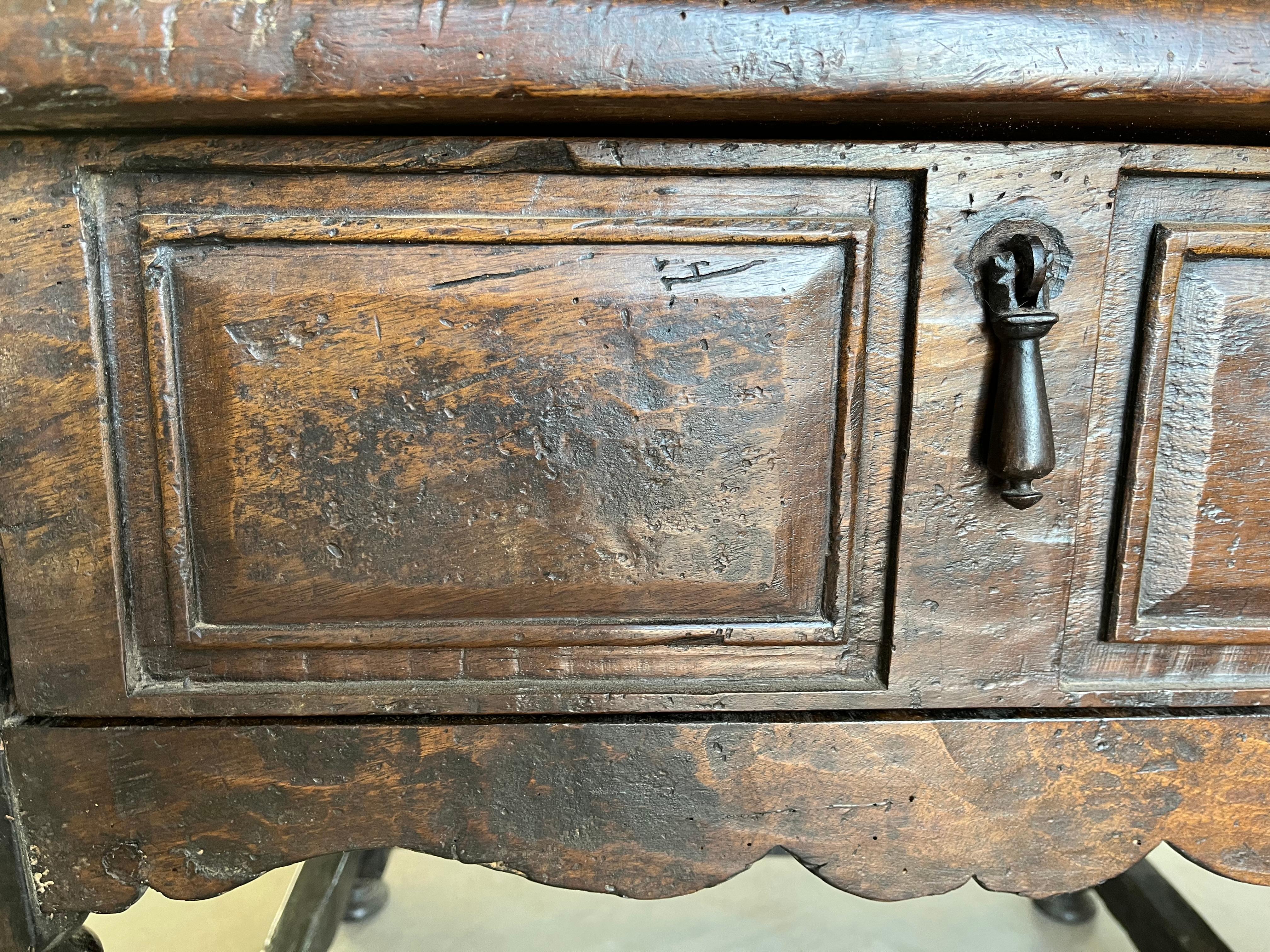 Beistelltisch, der um 1700 in Italien aus Nussbaum handgefertigt wurde. Der Tisch ist sehr stabil gebaut und einfach wunderschön. Die Proportionen, die Patina, die Farbe und die handgefertigten Schnitzereien machen dieses Stück zu einem Unikat.