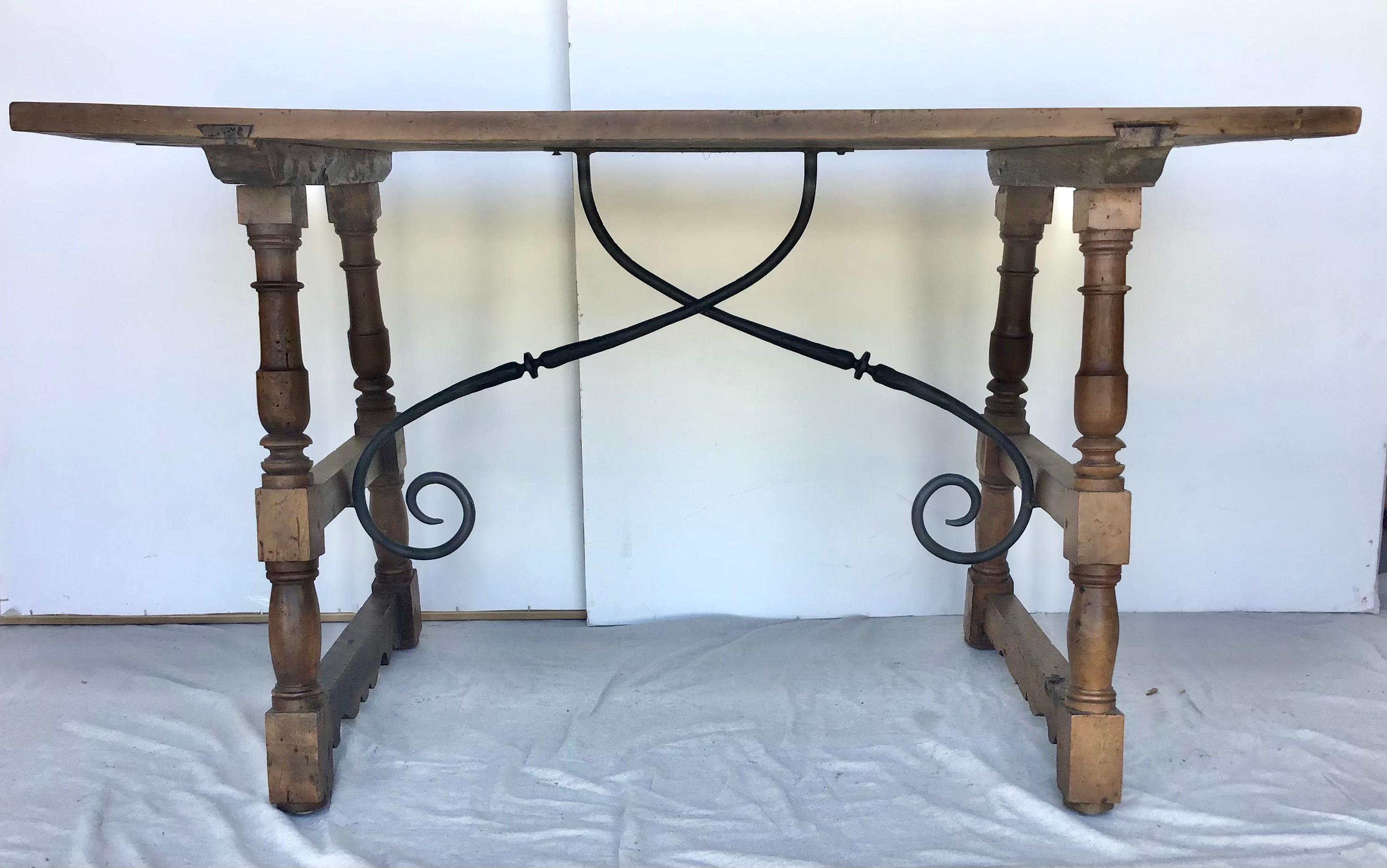 Italian, 18th century.walnut trestle or tavern table having a thick single board walnut top above turned legs with Iron stretcher. Perfect size to use as a writing table, sofa or center table.