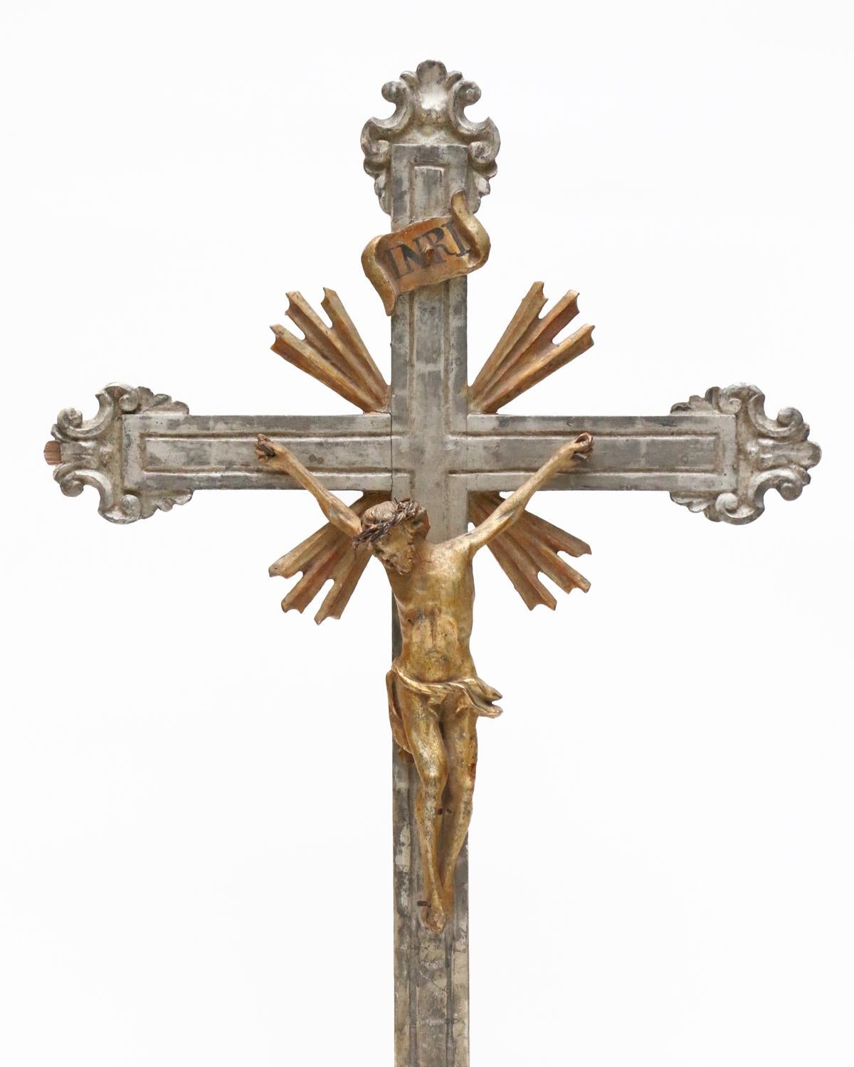 18th century Italian hand-carved silver leaf crucifix with a gold leaf figure of Christ and sunrays on a large calcite crystal in matrix base. 

The calcite crystal is from Elmwood Mine, Tennessee.  It is an example of the world's finest