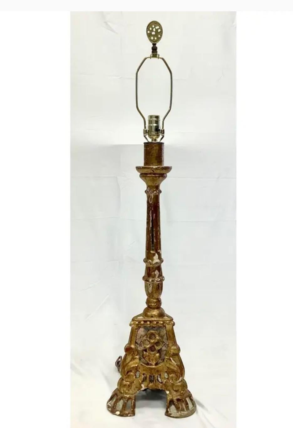 19th century Italian wood gilt candlestick lamp. Beautiful decorative details on every surface. Lamp rests on three scrolled feet. The harp is crowned with a charming brass finial. Base has mirrored mosaic pieces, some of which are cracked, giving