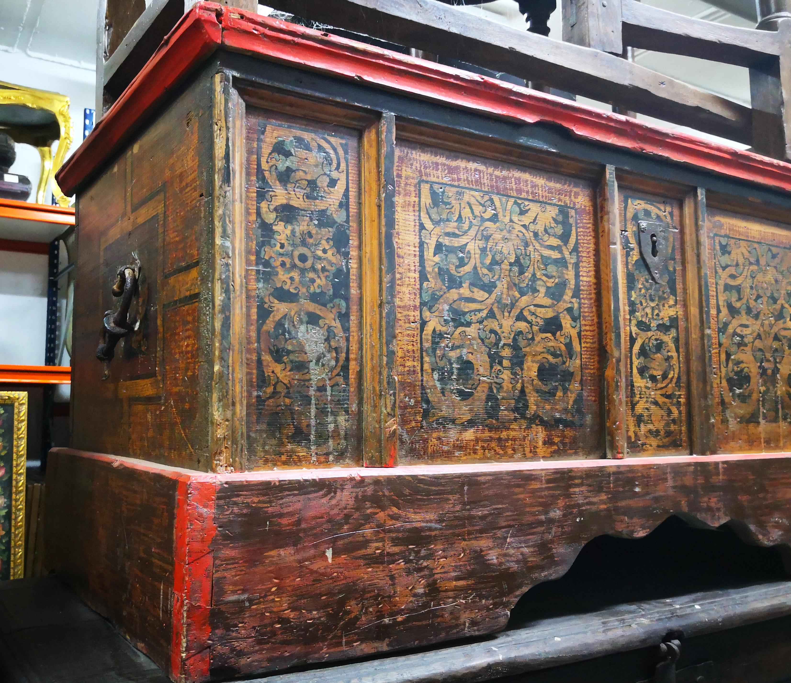 18th century Italian wooden painted chest with original iron work.

Front and sides painted with geometric patterns and vegetable scrolls, with characteristic wrought iron handles on the sides and a front bottom rounded skirt.
 