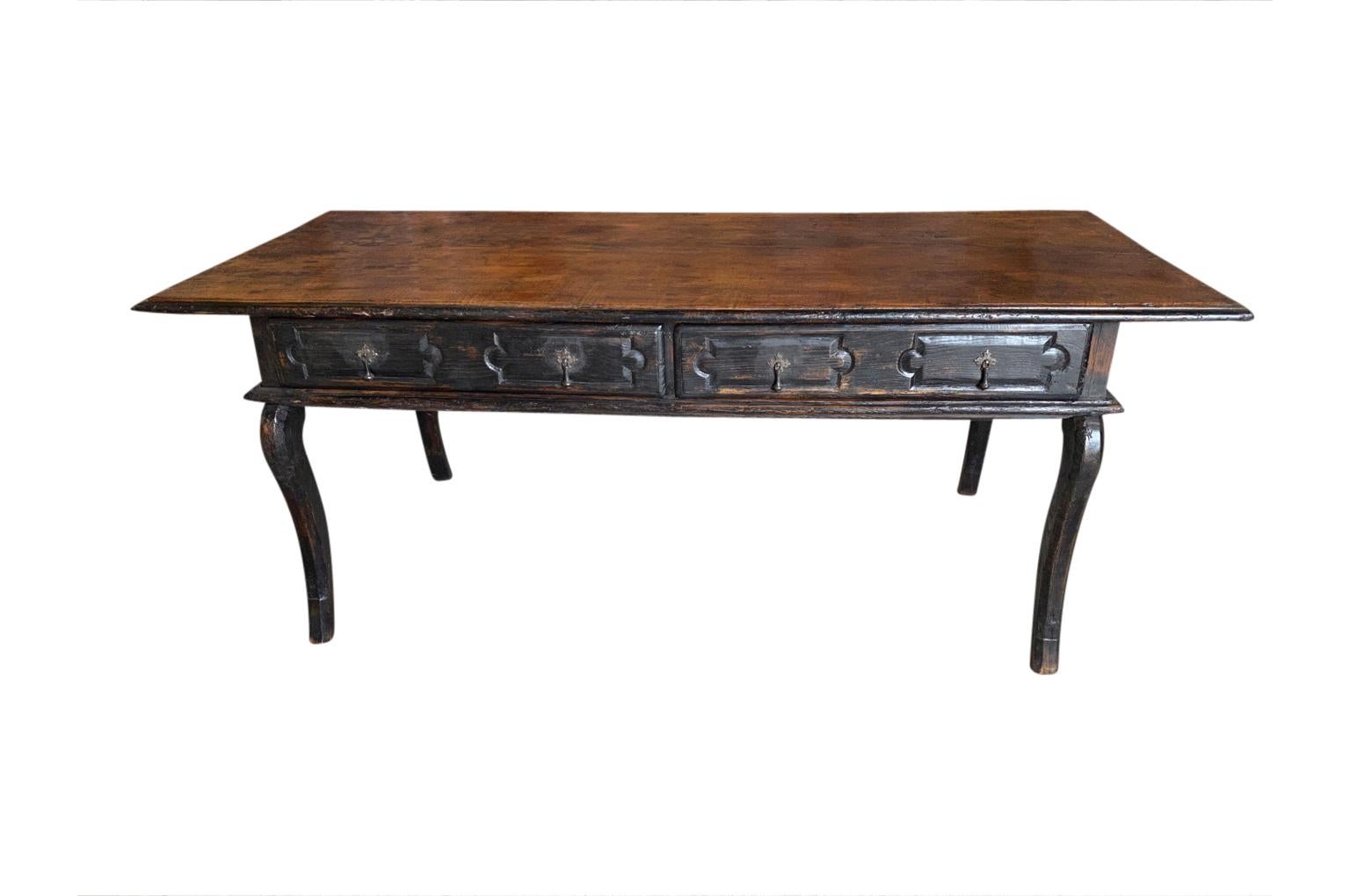 A very handsome 18th century writing table - desk from Tuscany. Beautifully constructed from painted chestnut with the top in a solid board of exposed chestnut, 2 drawers, molded panels all around resting on cabriole legs. Super patina.