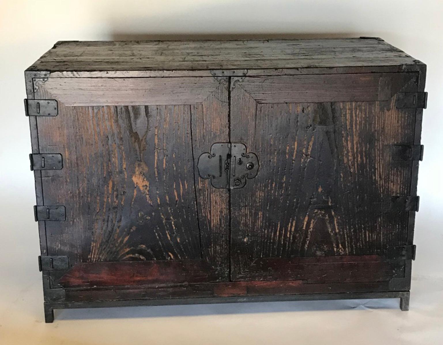 Japanese 18th century chest with beautiful original iron hardware. Two doors open revealing five interior drawers. Interior drawers are in excellent condition. Cabinet shows wear some wood deterioration but is still very handsome and sturdy and