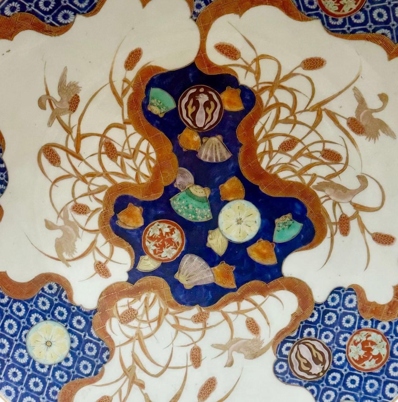 A striking example of 18th century Japanese craftsmanship, this Imari charger is a masterpiece of color, form, and decorative impact. Boldly hand painted with rich cobalt blue, iron red, and gilt accents, it exemplifies the drama and sophistication