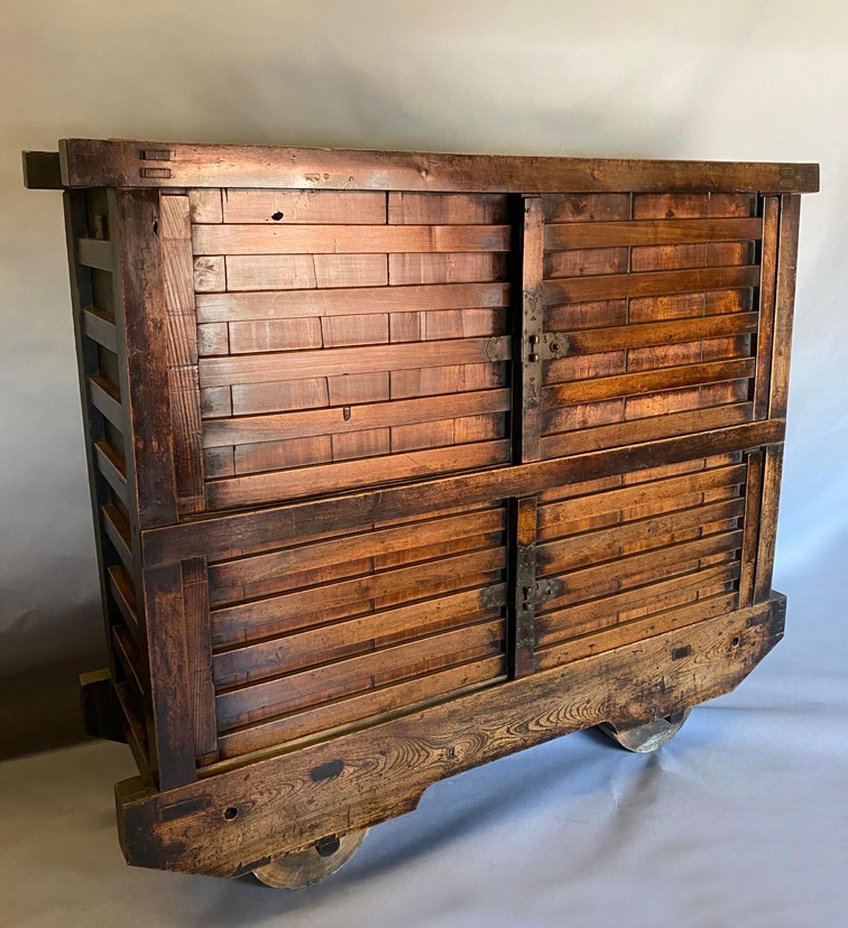 19th c. Kuruma tansu - cabinet on wheels. These were used to store belongings and the wheels made them easy to move outside during house fires, which were very common in Japan where homes were made solely of wood.
These storage pieces on wheels