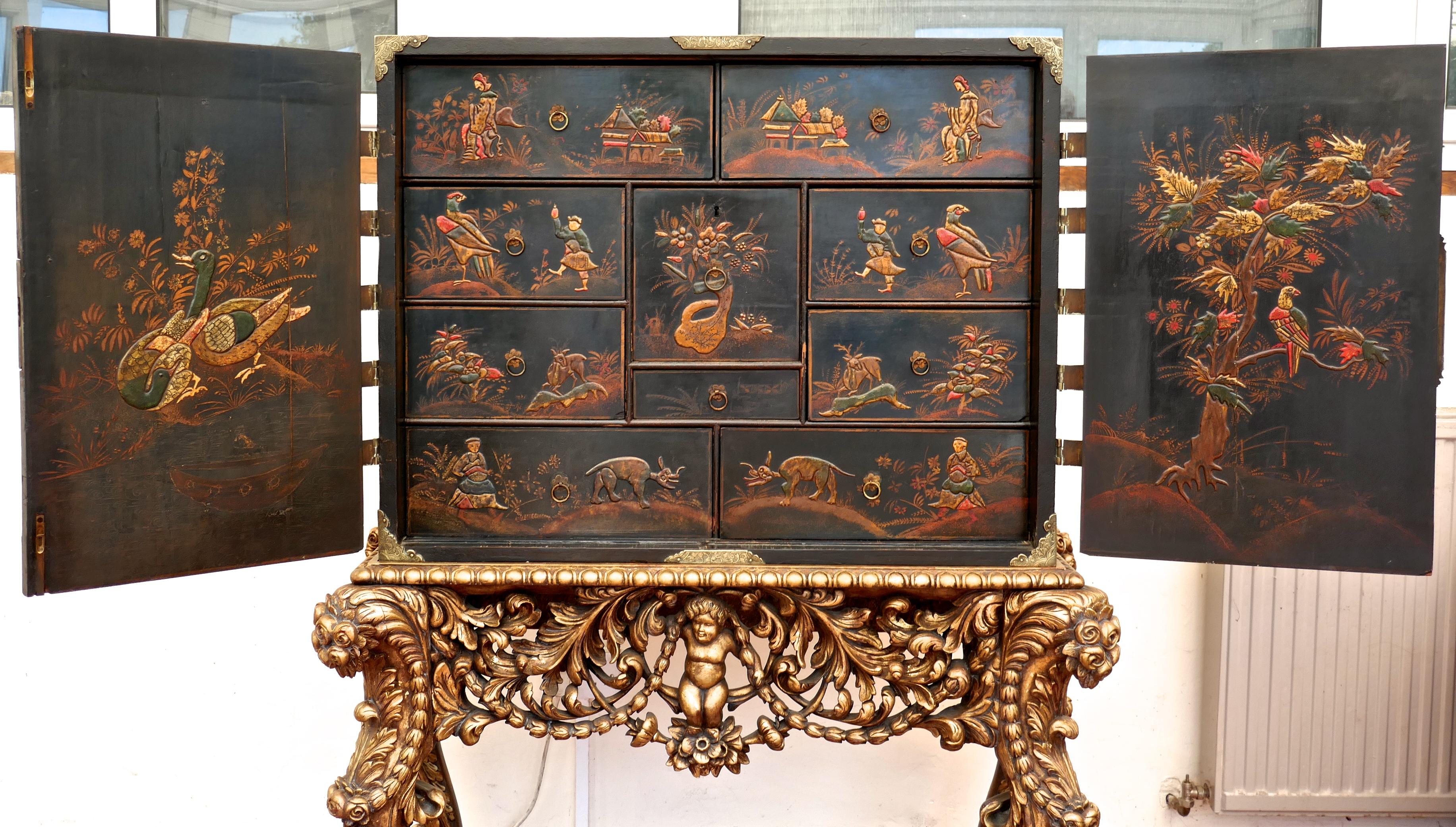 18th century Japanned collectors cabinet on stand, Clive of India. 

This wonderful collectors cabinet dates from the early part of the 18th century it has large doors enclosing ten drawers all of different sizes, the cabinet is japanned and