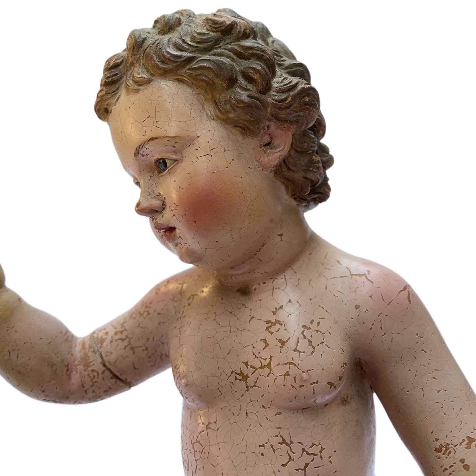 18th century Jesus Child Terracotta Sculpture an Italian Holy and devotional art polychromed figure  depicting Baby Jesus standing on an a carved and gold leaf giltwood square shaped pedestal. This basement top is unfinished and should have