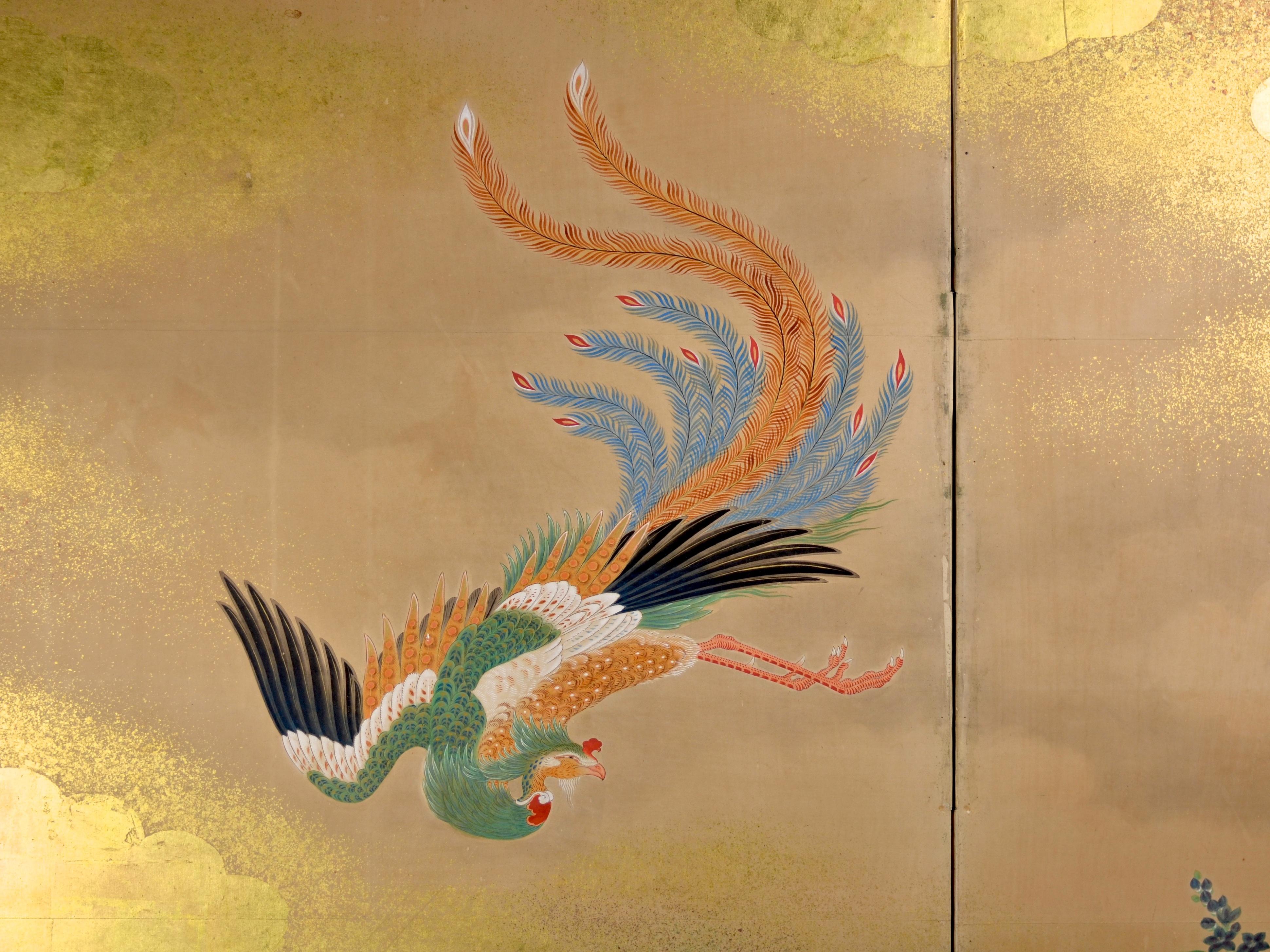 Wonderful two-panel folding screen with painting of a phoenix descending between gold clouds to a river shore where a paulownia tree grows - which is believed to be his resting place. The screen was painted by a master Kano painter, however,