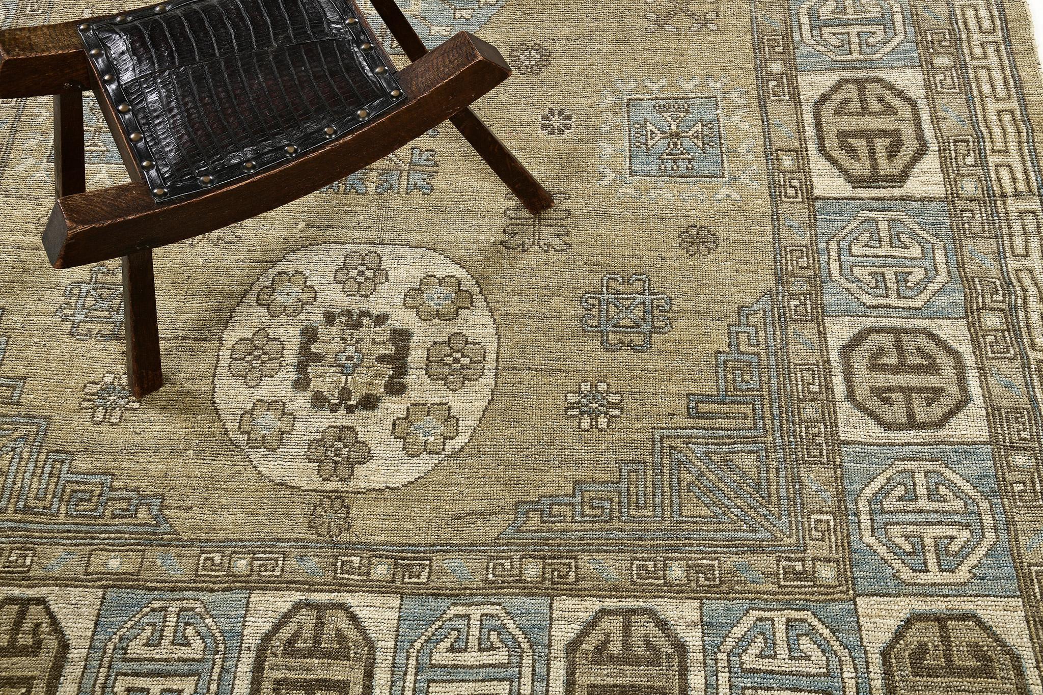 A warm and inviting Khotan Design revival rug that beautifully embodies combining influences from Chinese, Persian and Turkish designs. The abrashed tan field is covered with distinctive ornate stylish patterns enclosed by alternating gul border