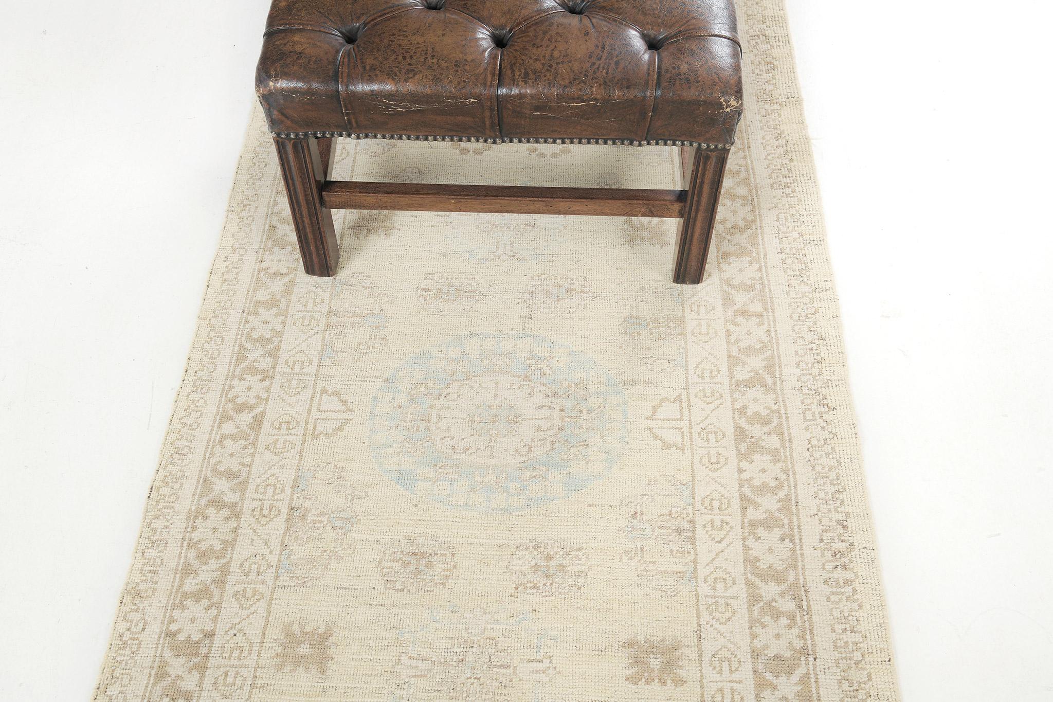 A stunning pile-woven wool Khotan design revival from our collection fits perfectly in your home.  Three geometric medallions and well-aligned motifs in neutral tones dominate the entire pattern of the runner. There are also gorgeous floral bands