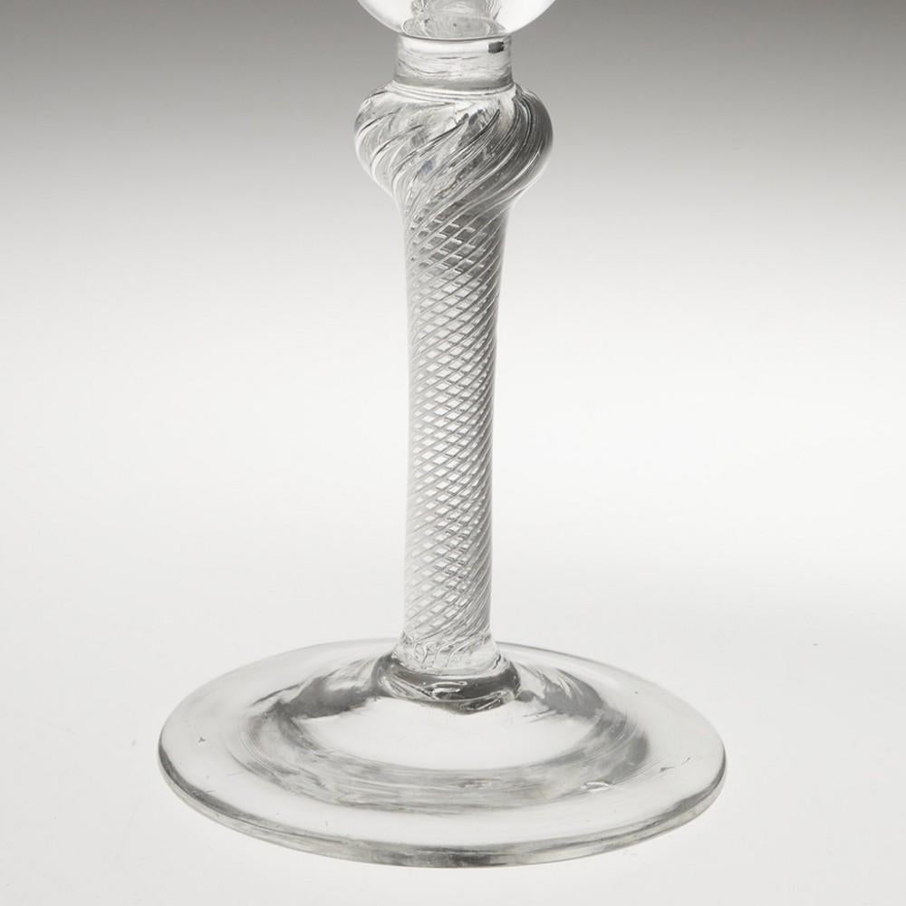 Heading : Air twist stem Georgian wine glass
Period : George II - c1750
Origin : England
Colour : Clear
Bowl : Round funnel
Stem : Short plain section above a multi spiral air twist with flattened ball knop
Foot : Conical
Pontil : Snapped
Glass Type