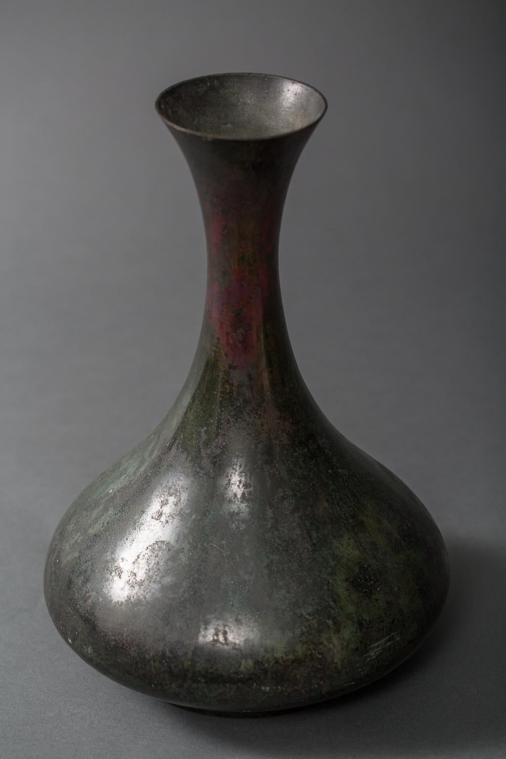 18th century Korean bronze vase. Beautiful green patina with dashes of red. Wonderful exaggerated silhouette. Collector's signature on the bottom.