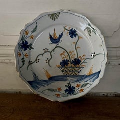 18th century La Rochelle faience plate with basket and bird decoration