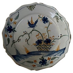 18th century La Rochelle faience plate with basket and bird decoration