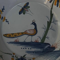 18th century La Rochelle faience plate with peacock and butterfly decoration