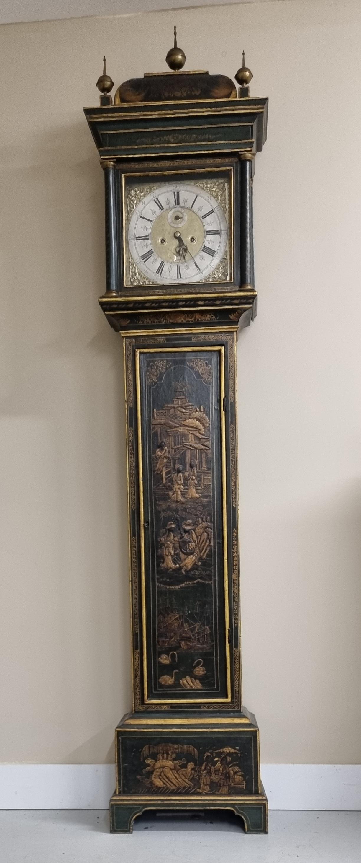 A superb mid 18th-century London longcase clock, finished in green japanned lacquer with gilt scenes of figures, pagodas, and landscapes. The clock features a silvered brass dial with Roman numerals, matted center, and gilt spandrels, all framed by