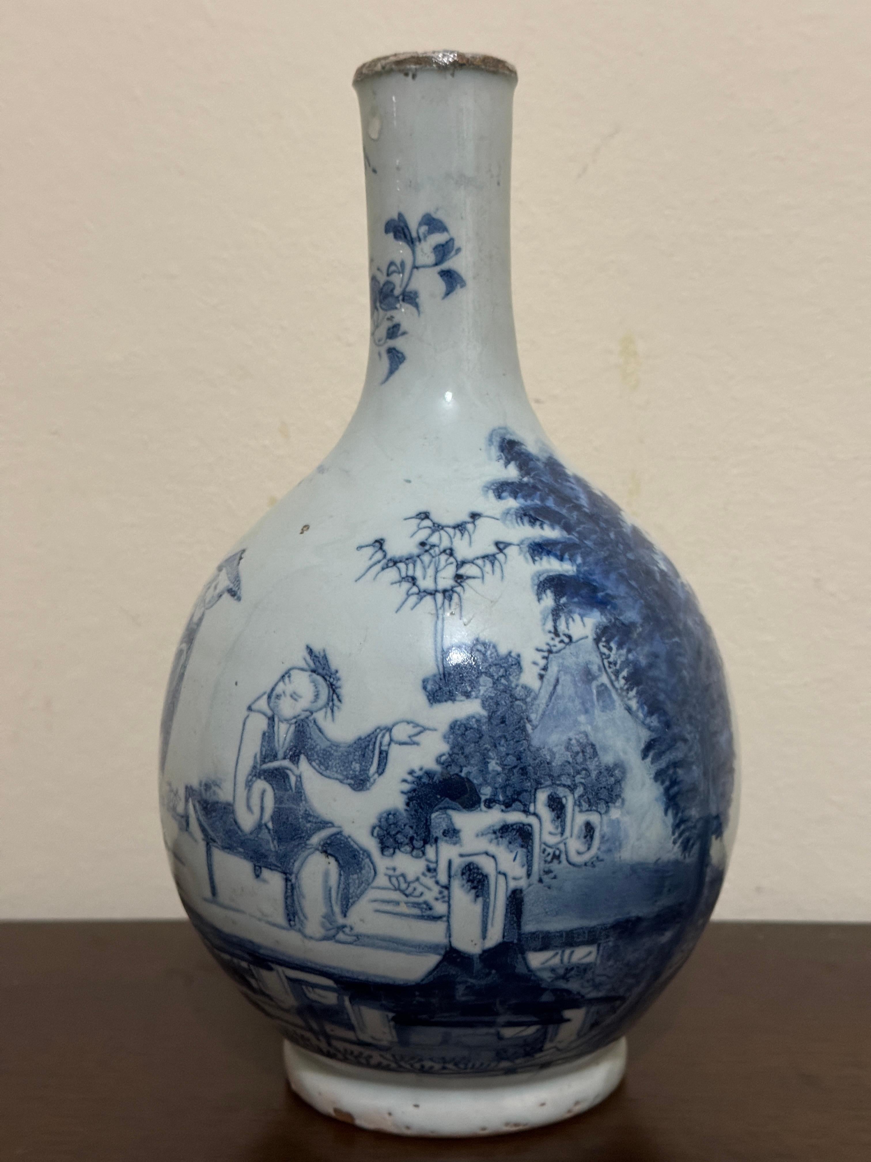18th Century Blue and White Delftware Bottle, English and probably from the Lambeth pottery in London, tin glazed earthenware with a hand painted oriental scenes. Height 9