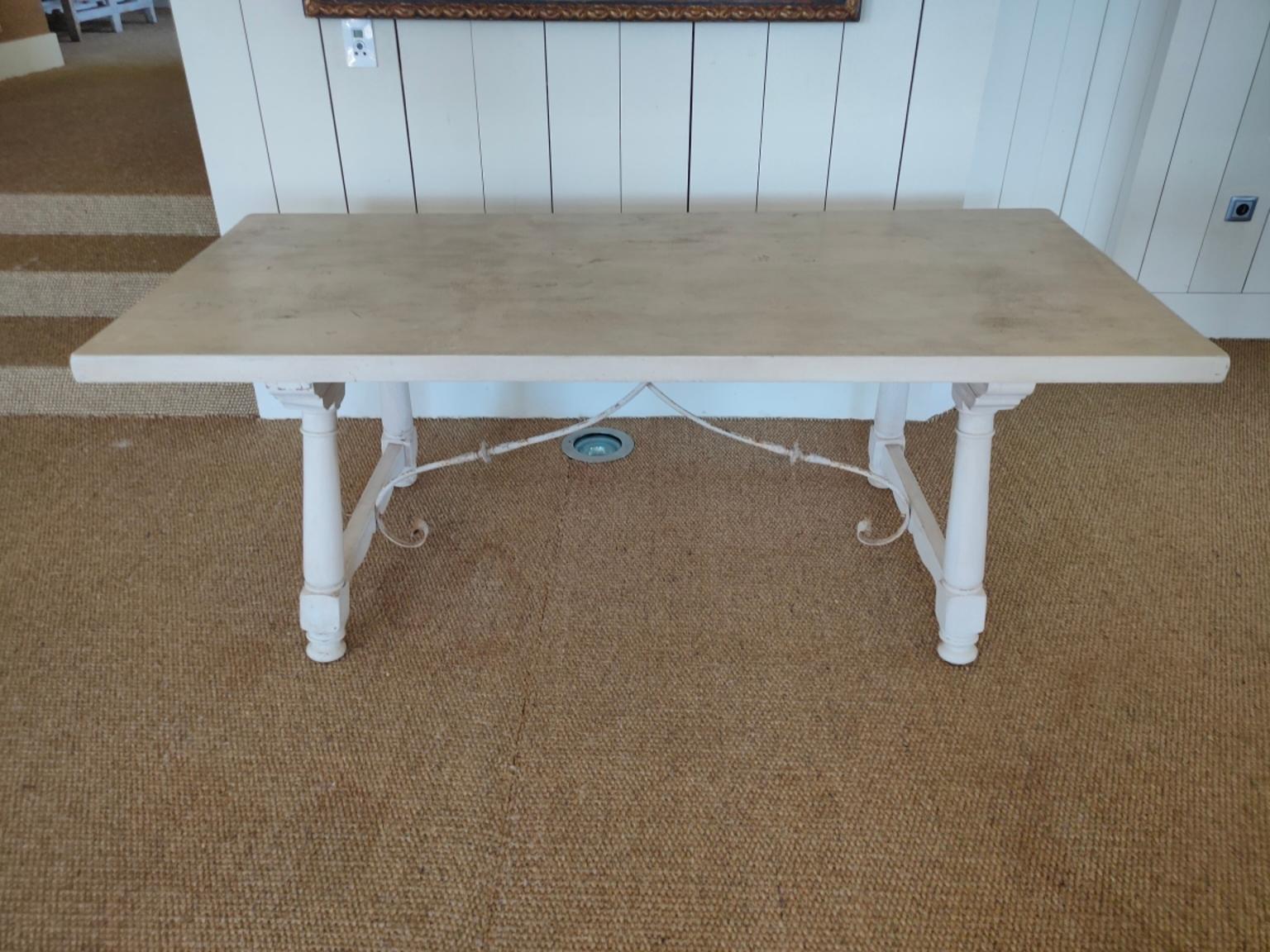 A 18th century bleached solid oak Spanish dining table with scrolled wrought iron stretcher, with decorative carved turned legs t. In excellent clean condition.
  